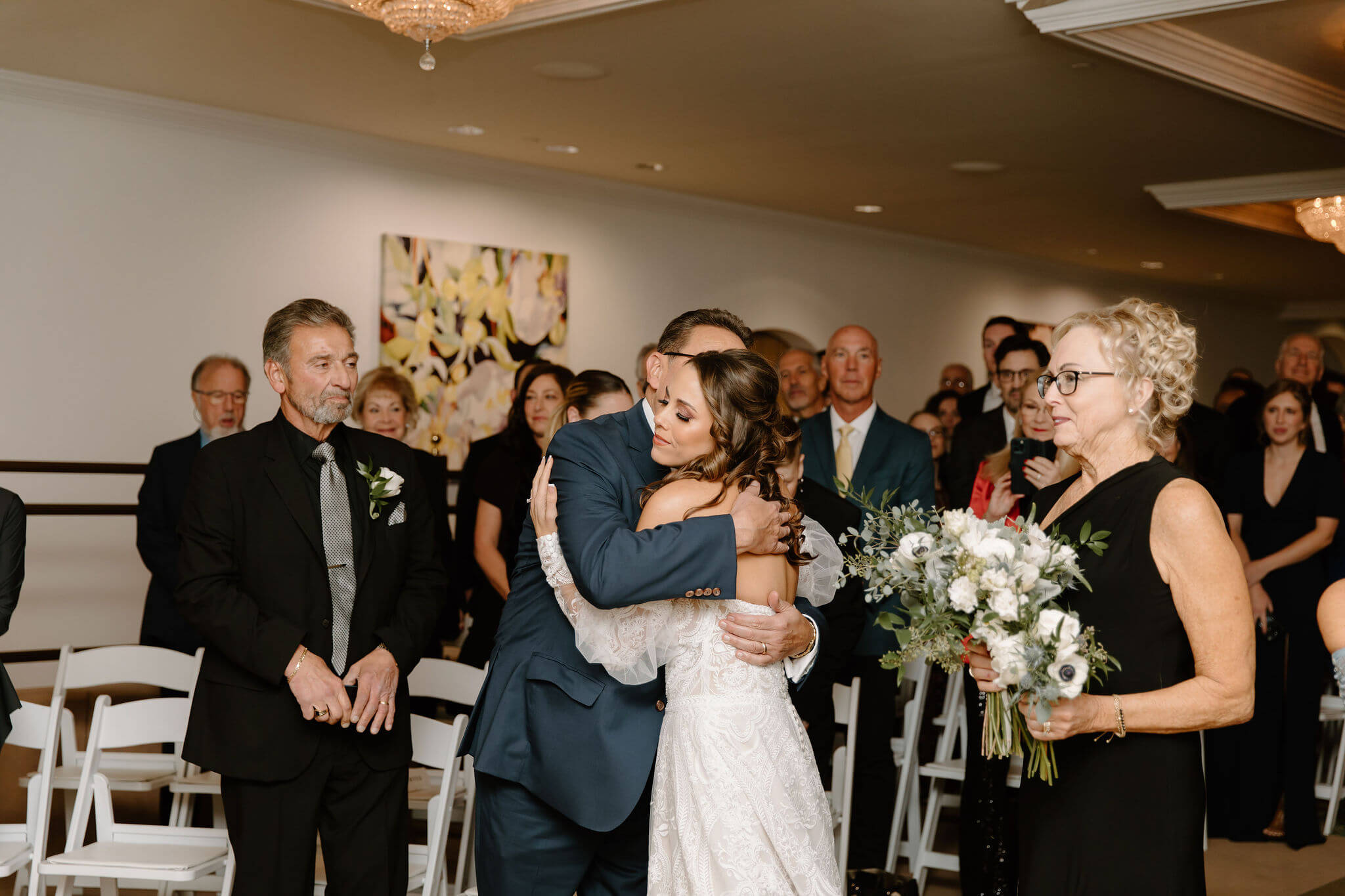 bride hugging her dad after being walked down the aisle at her wedding ceremony