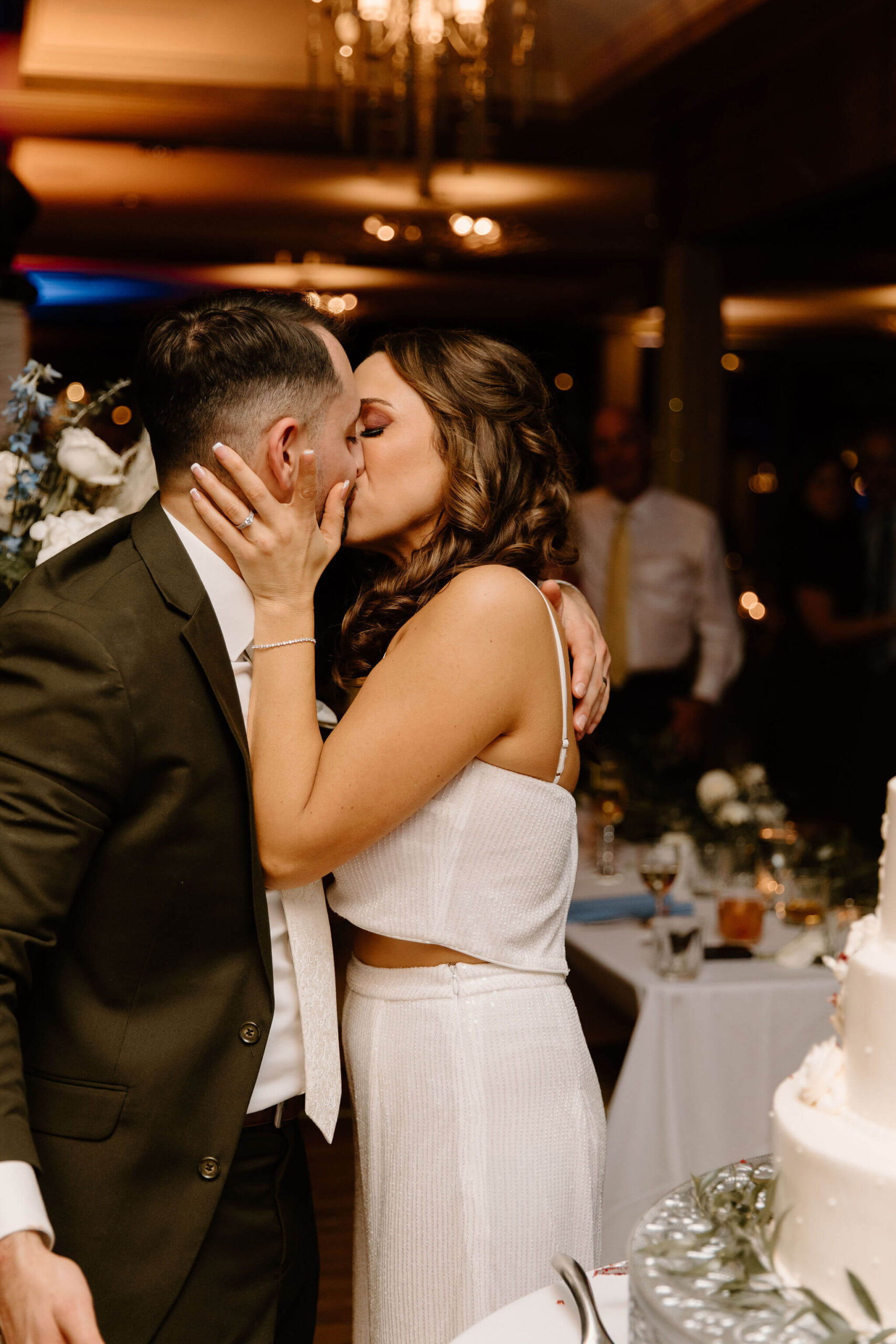 bride and groom kissing passionately during their wedding reception