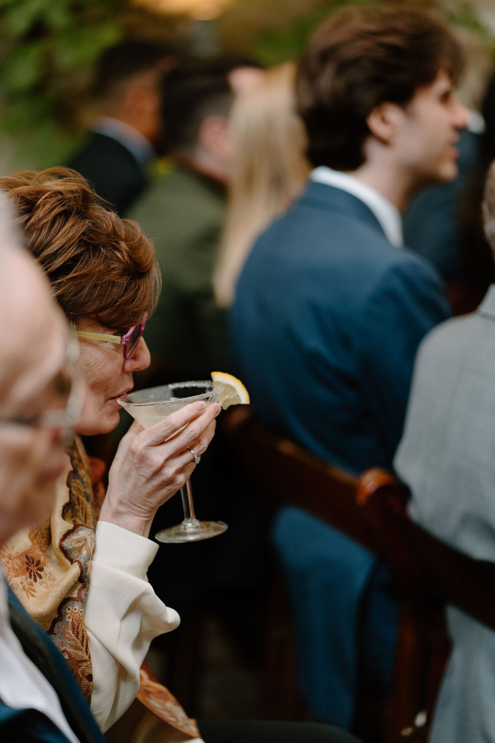 guest sipping her lemon martini during the ceremony