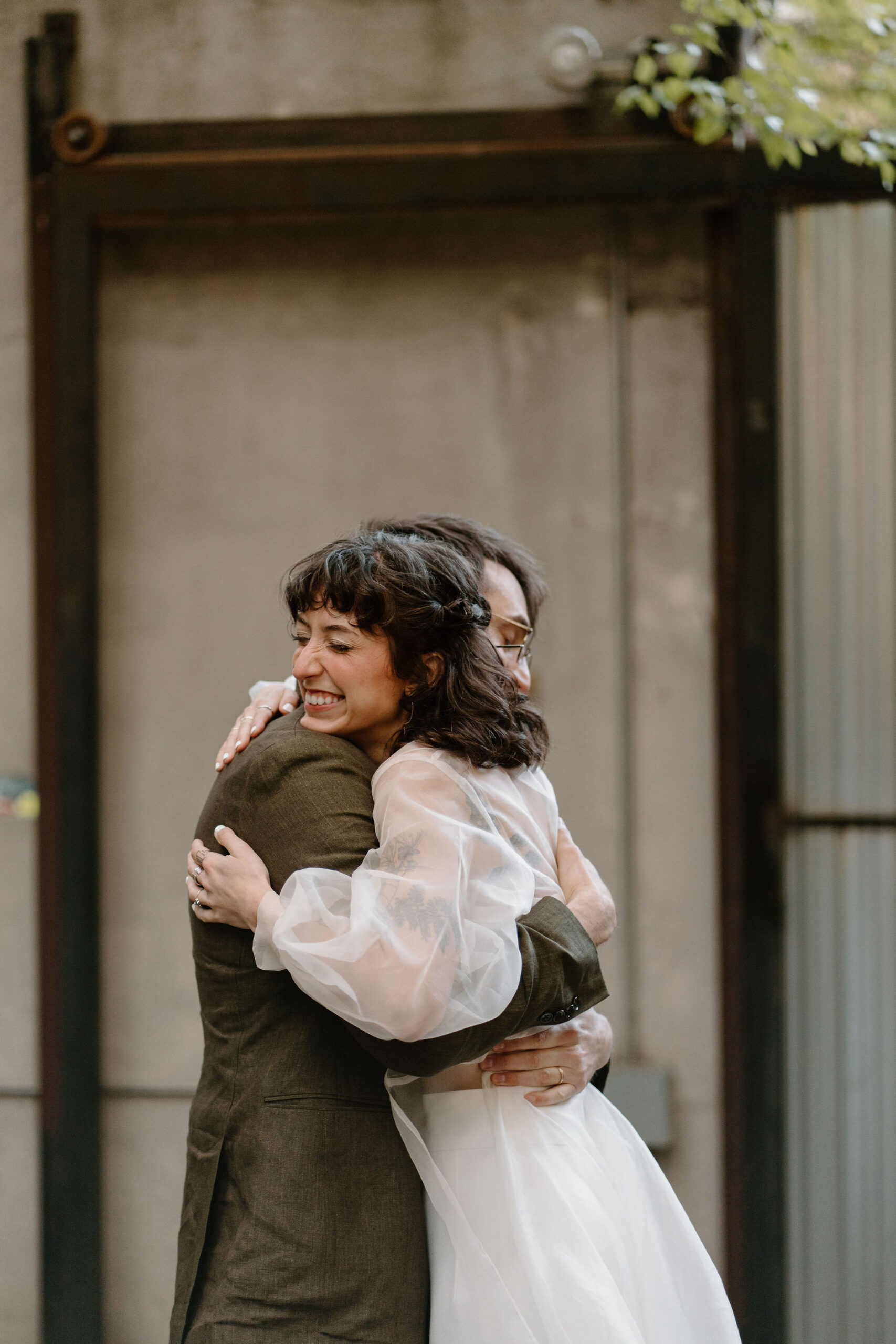 close up of bride and groom hugging and smiling