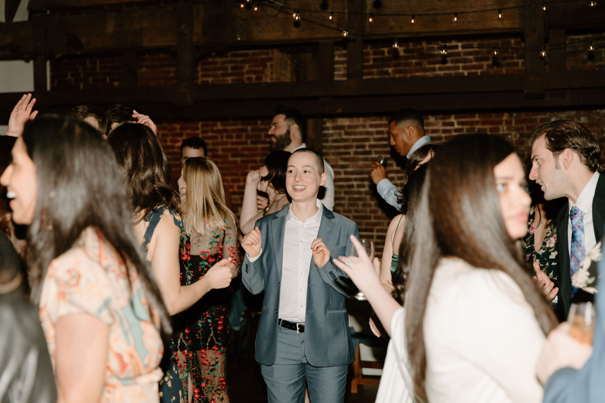 a guest smiling and dancing during the reception