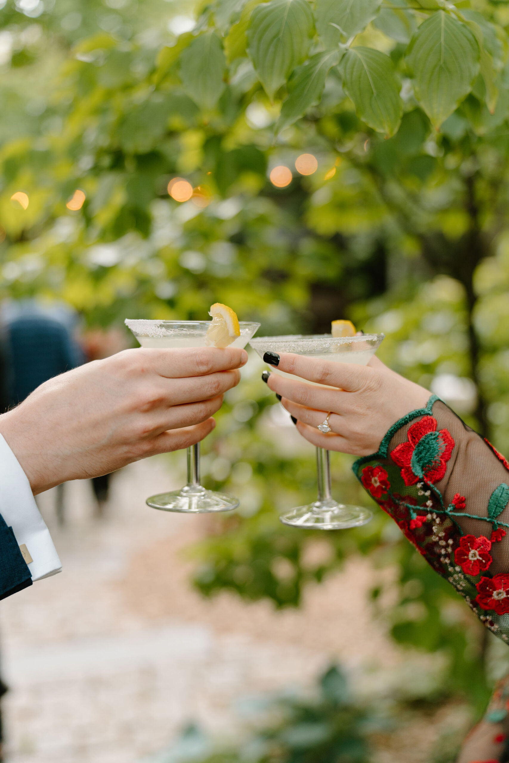 close up of two guests toasting their martini glasses together