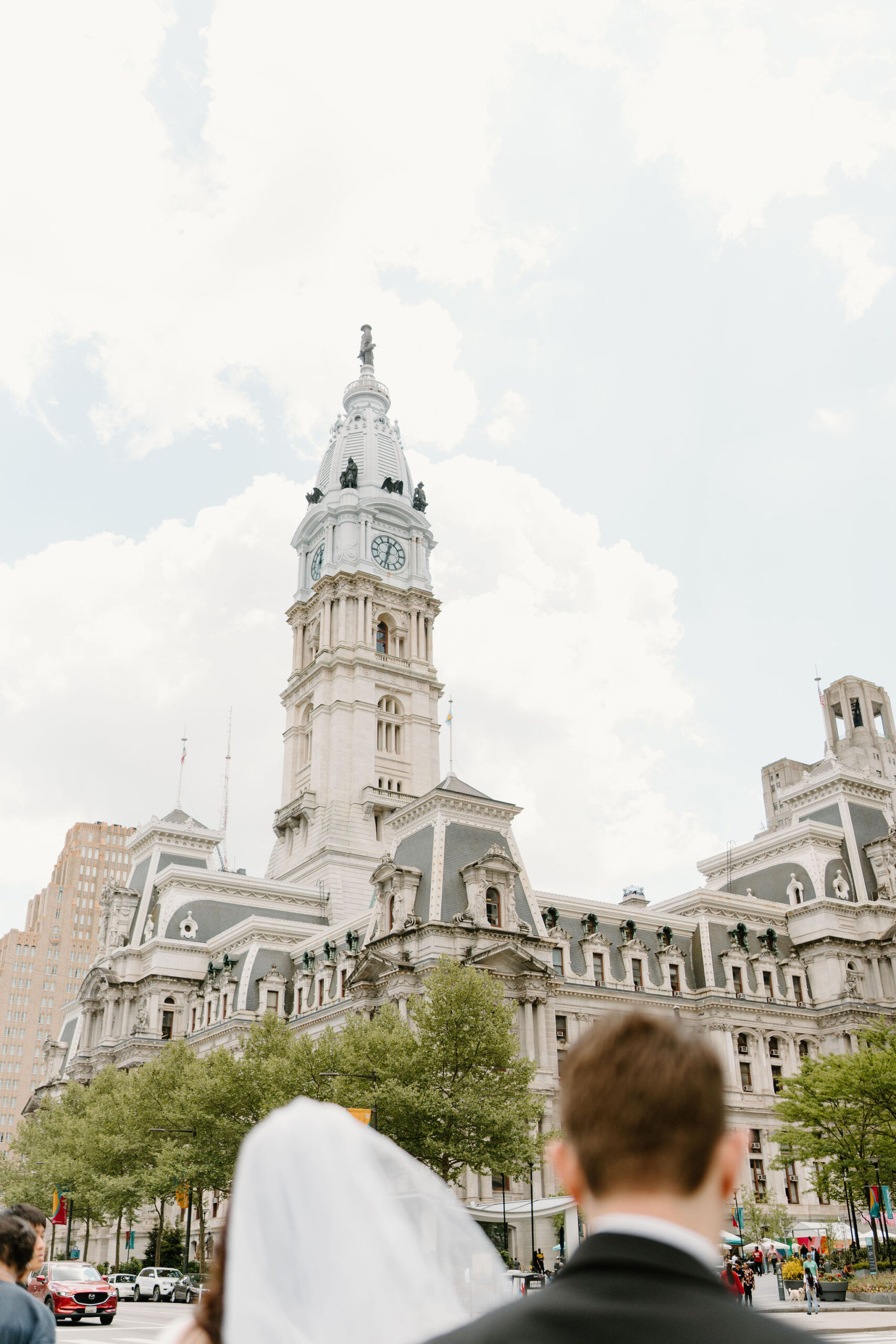 image of City Hall, between bride and groom's heads (out of focus)