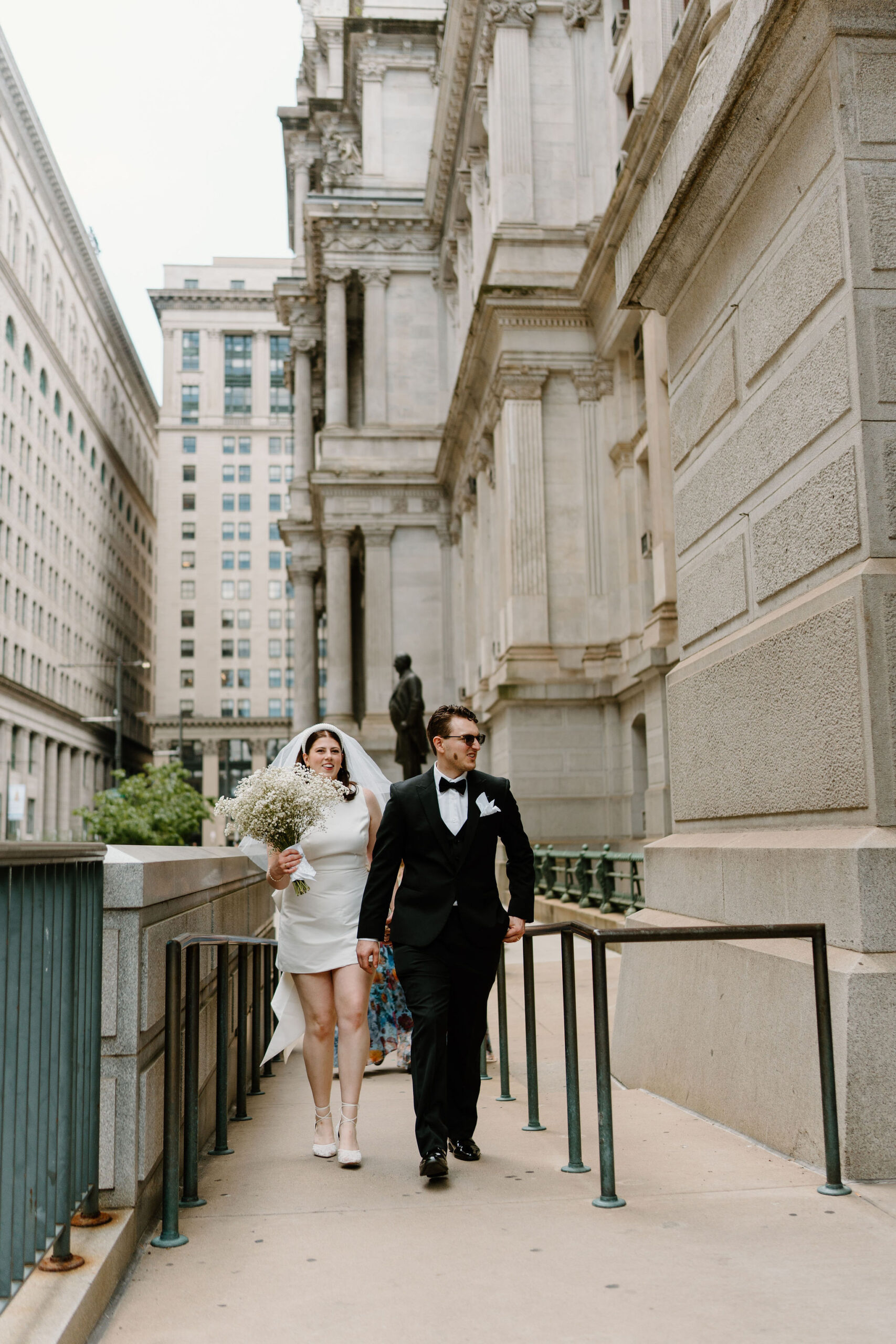 bride and groom walking up a ramp to enter city hall