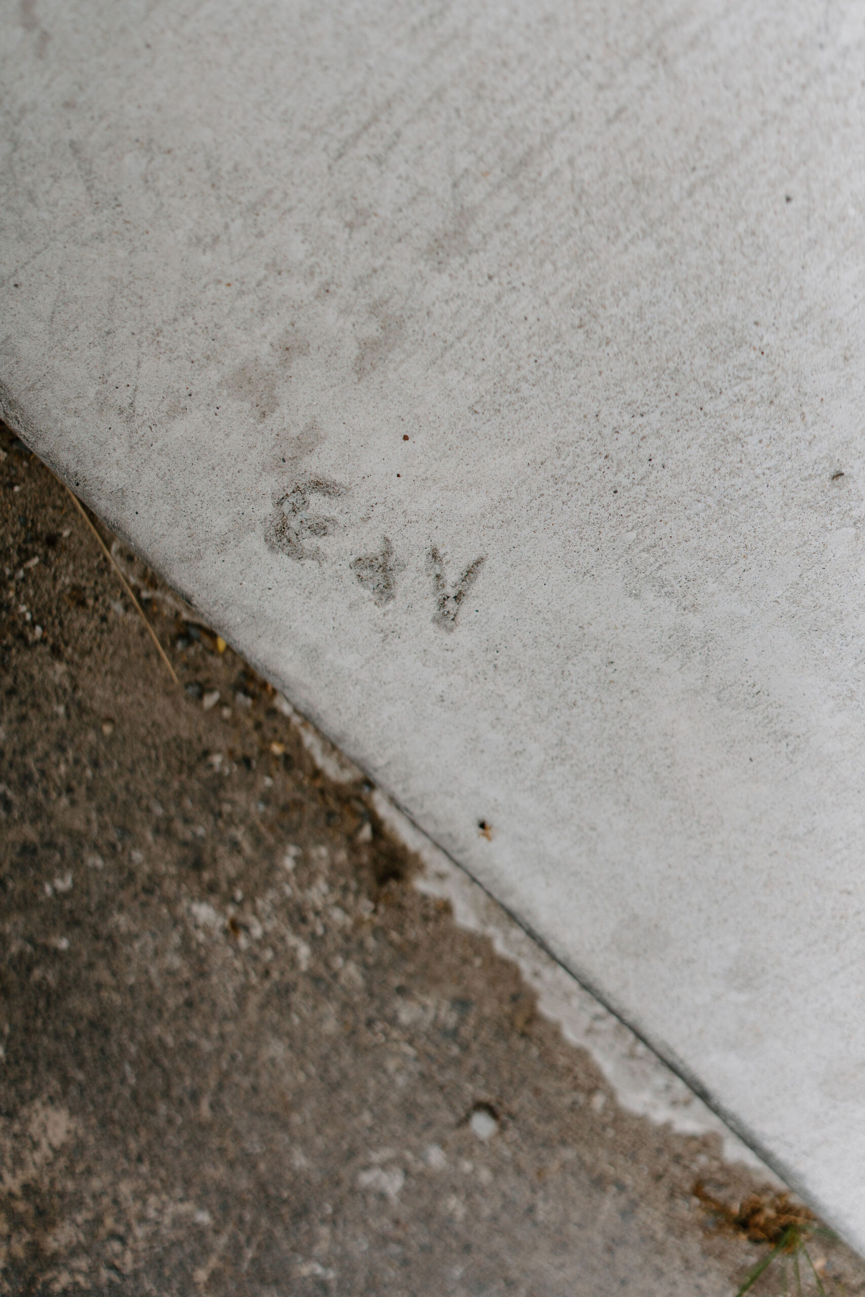 carving in concrete of "E+V"