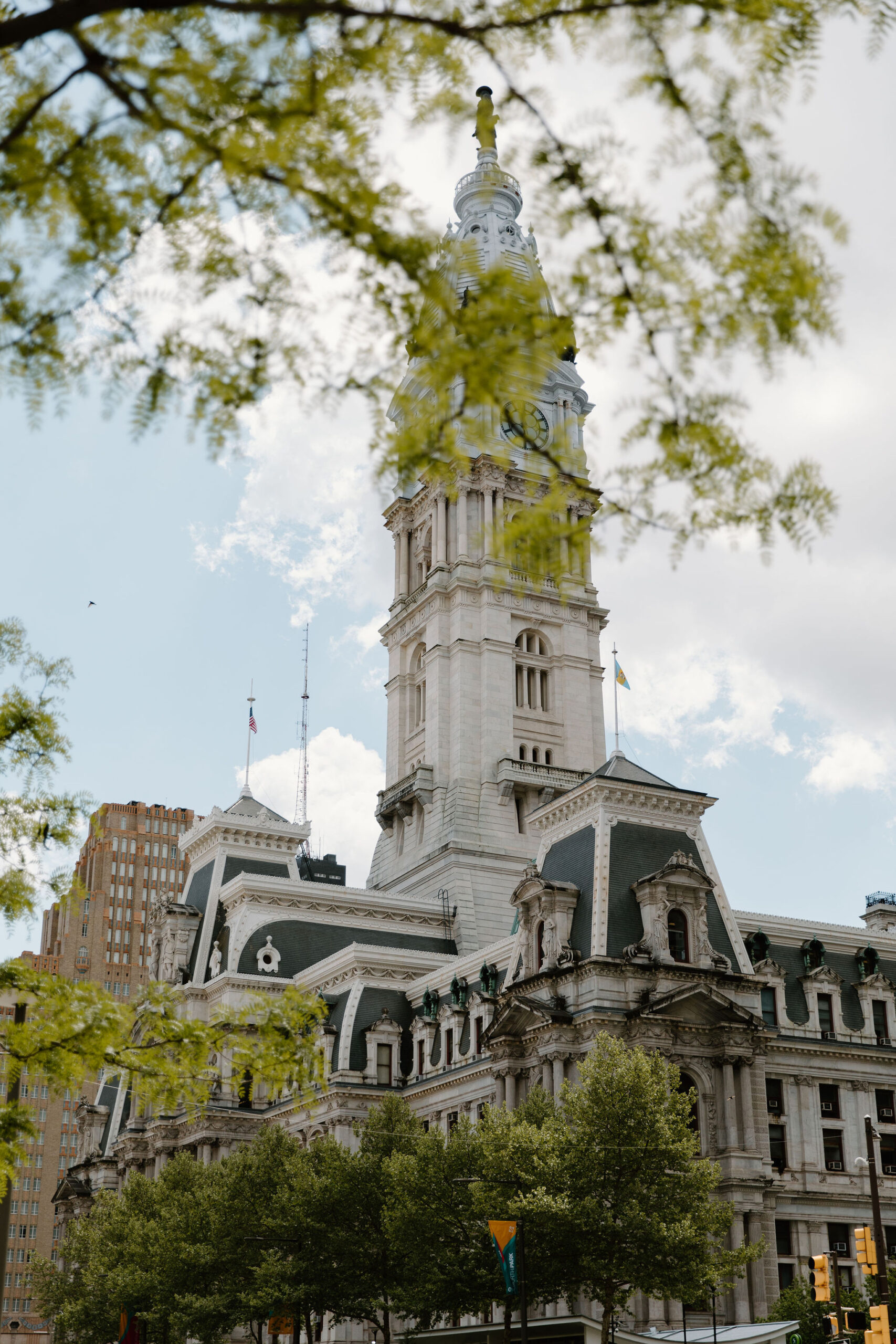 City Hall, Philadelphia, on a sunny day, photographed with green trees in the foreground