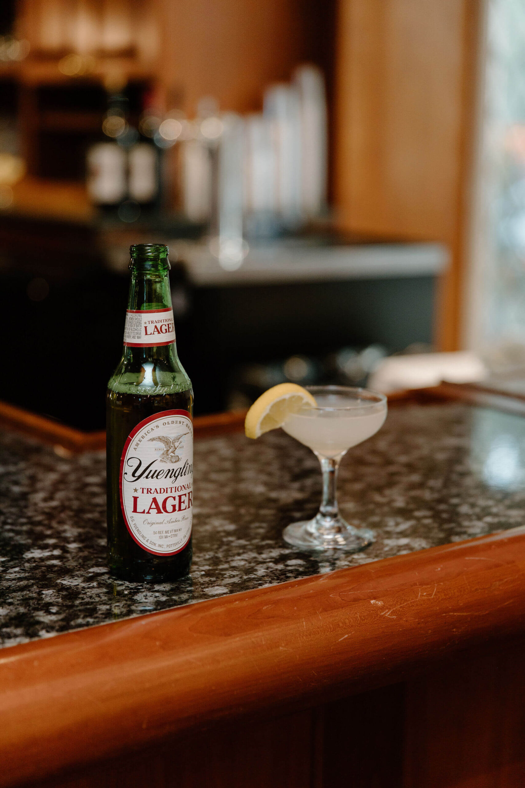a Yuengling beer and a lemon drop martini set on a bar