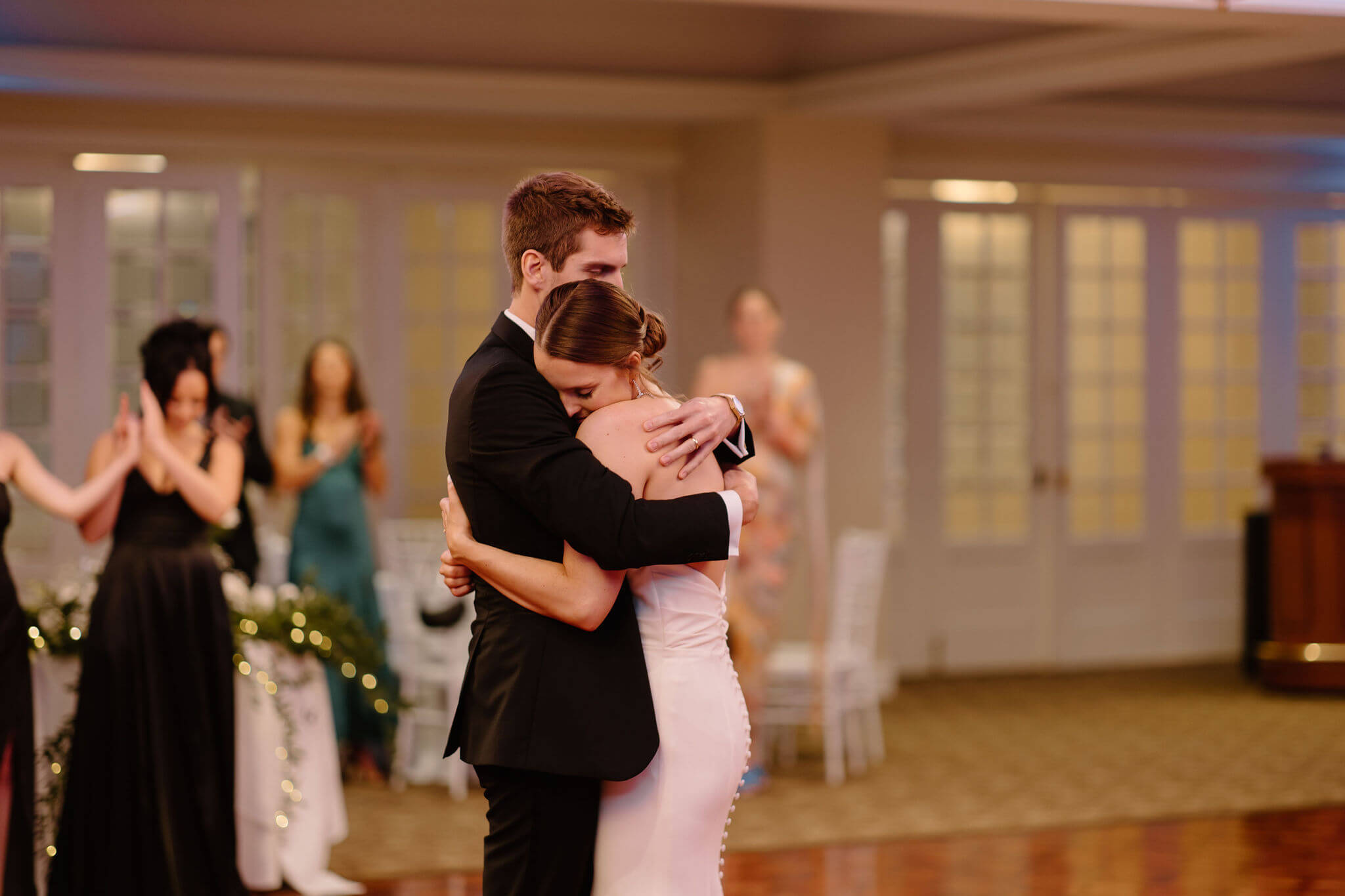 bride and groom hugging tightly during their first dance