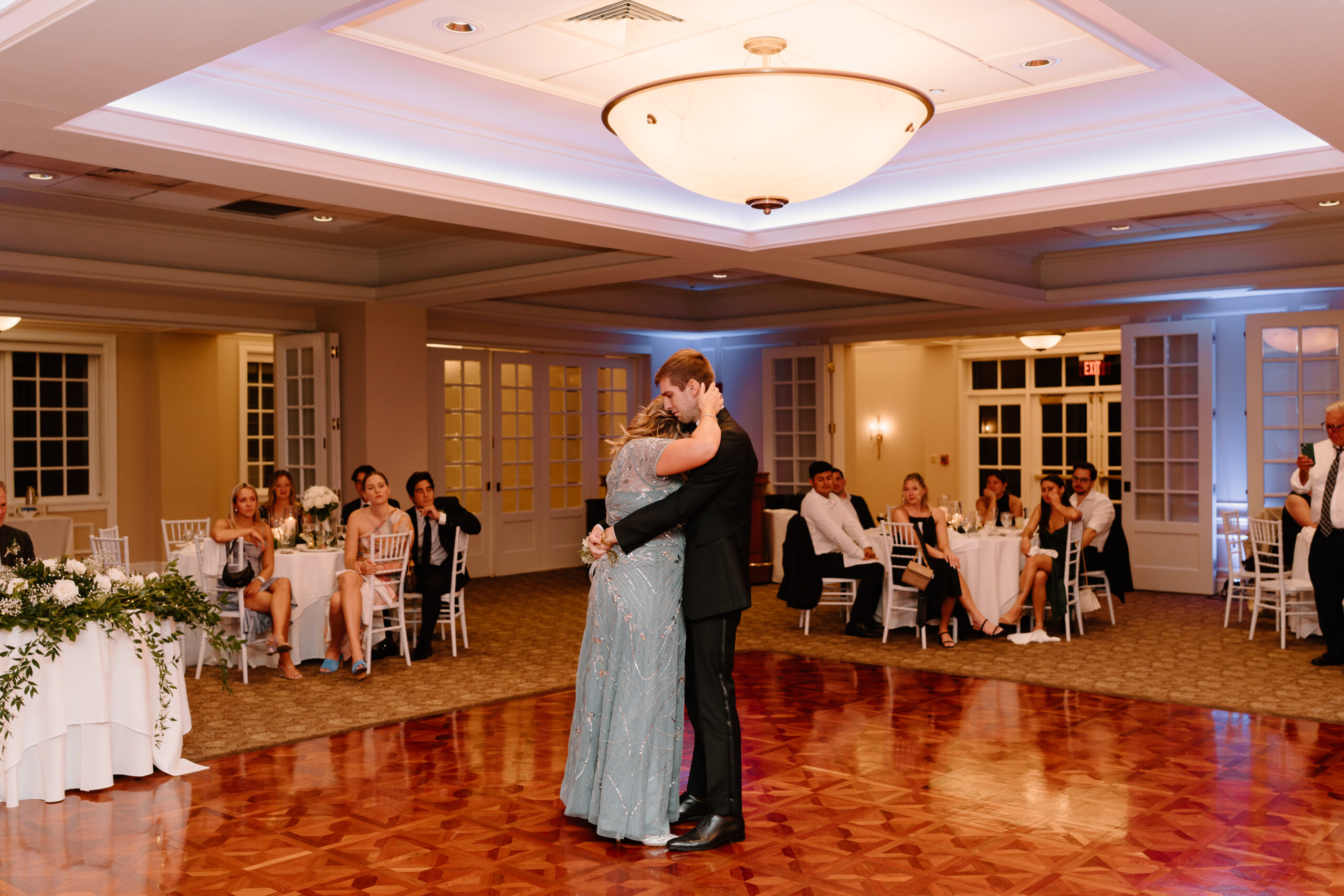 groom and his sister having an emotional first dance at his wedding reception