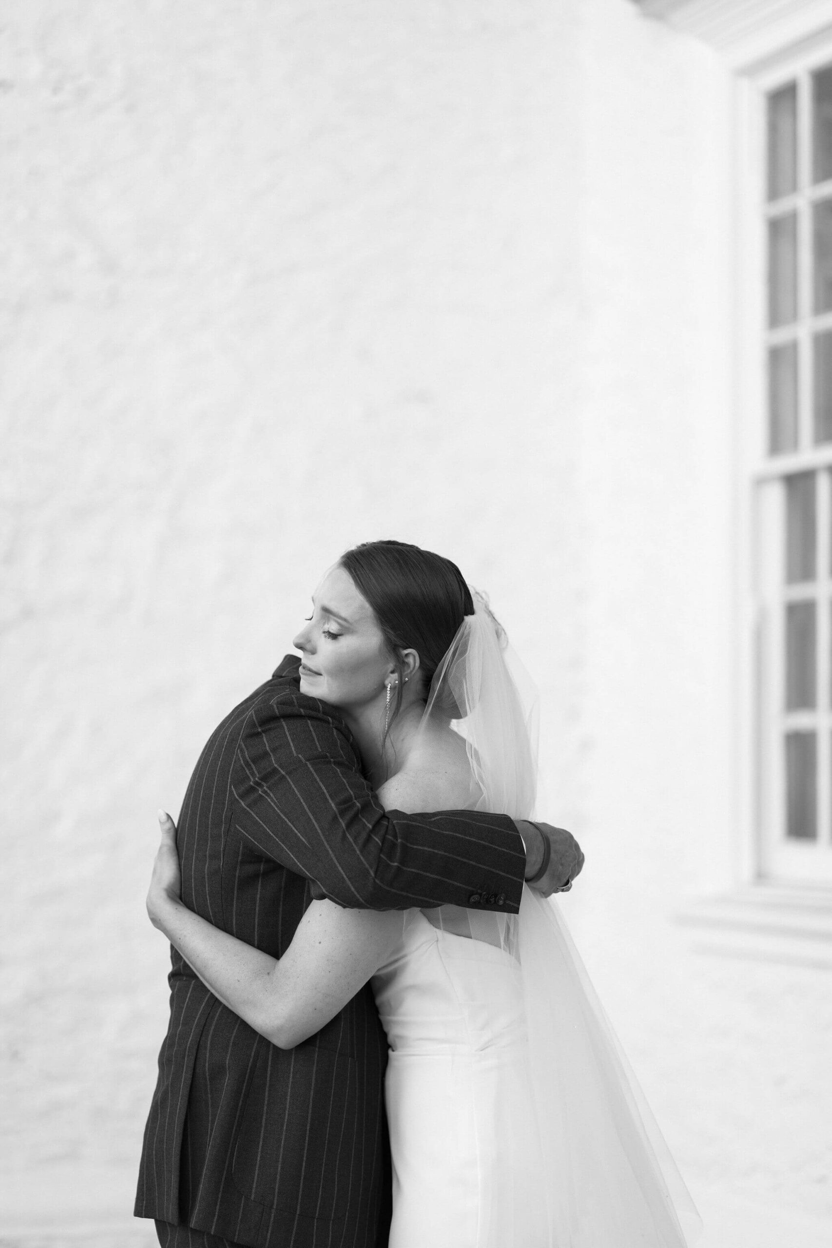 bride embracing her father and crying after their first look