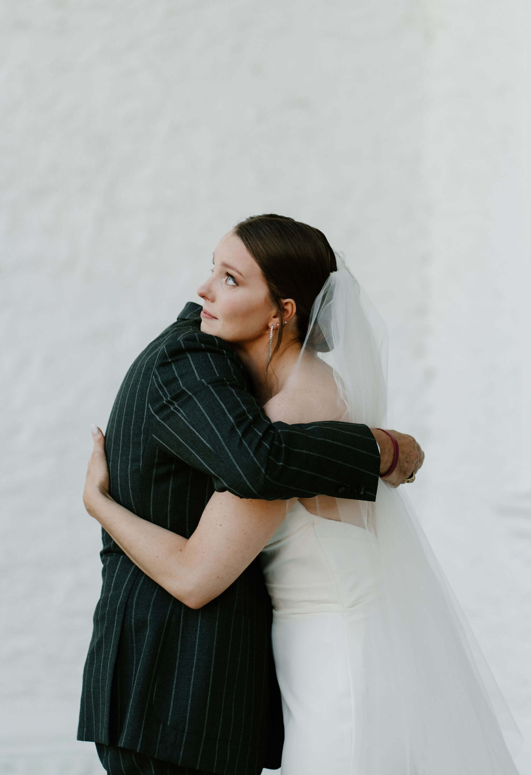 bride embracing her father and crying after their first look