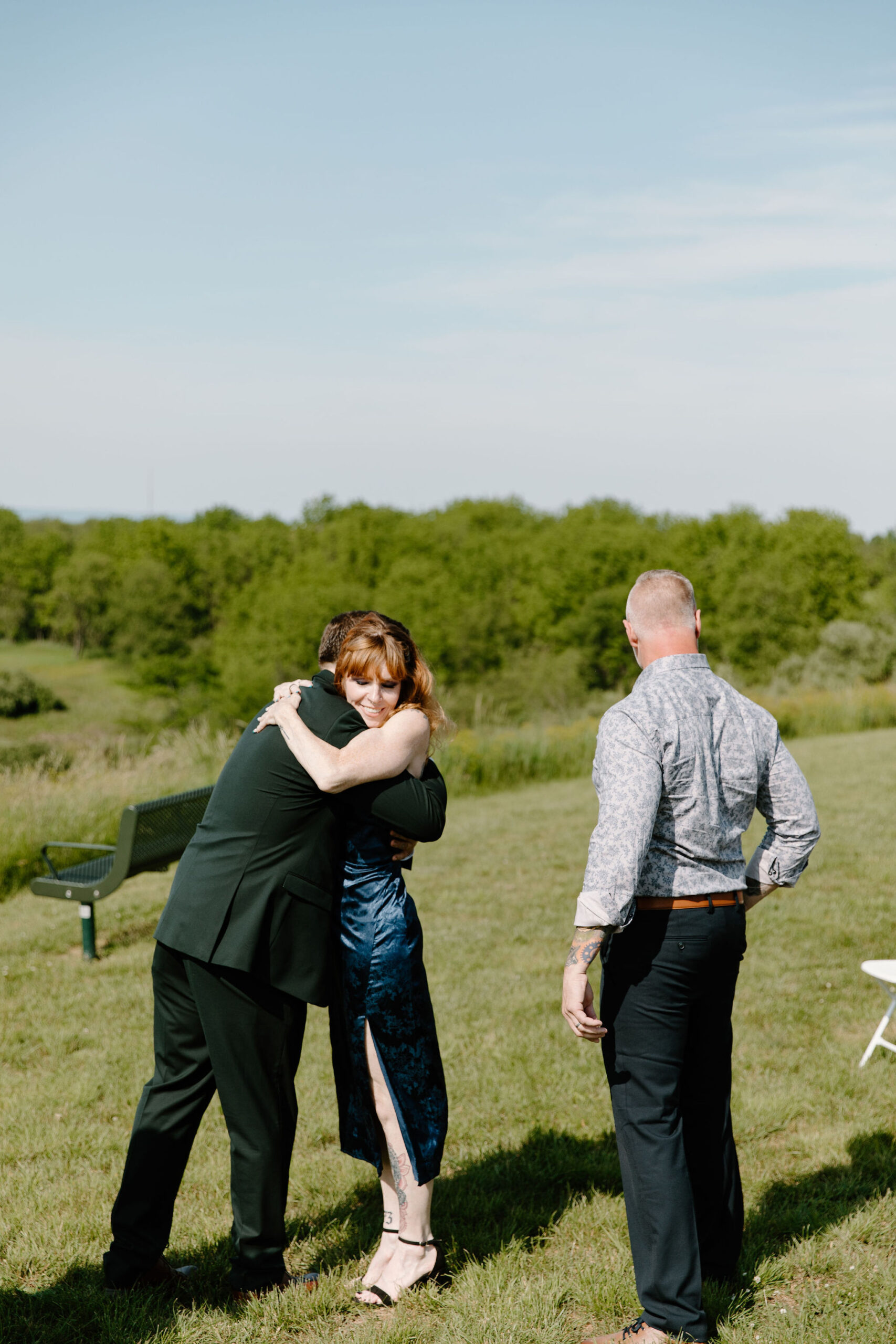 mother of the bride hugging the groom after walking the bride down the aisle