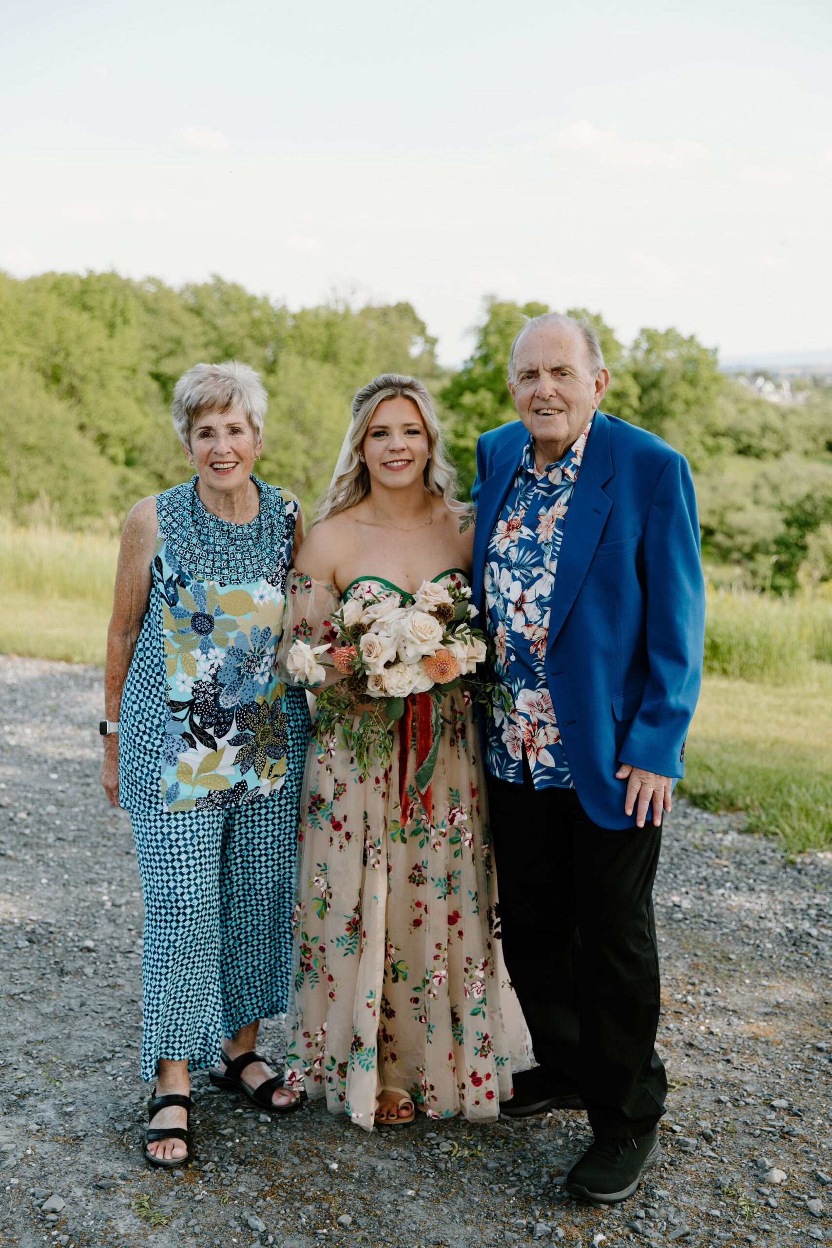 bride smiling for a picture with her grandparents