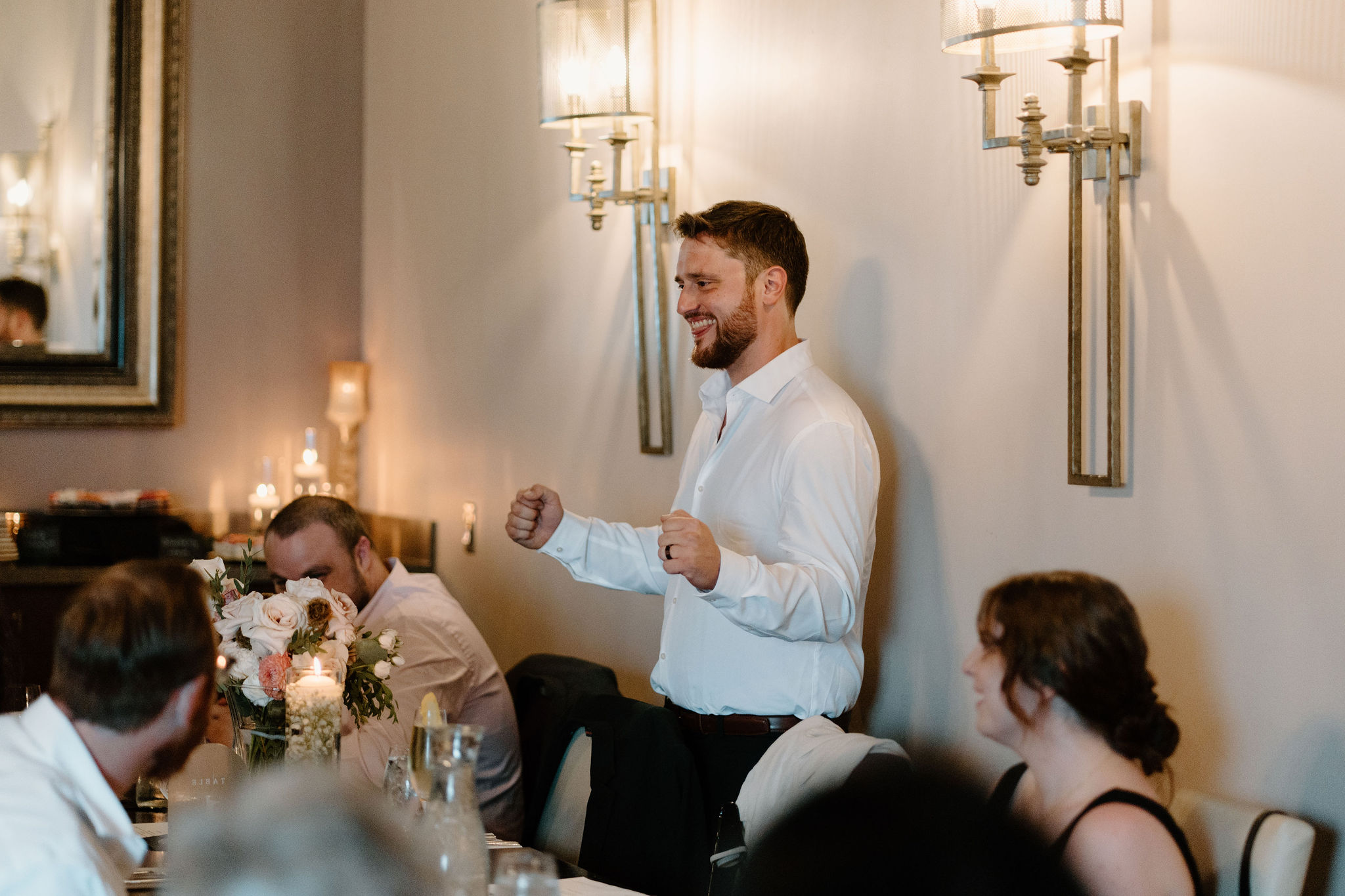 groom during cocktail hour, smiling at his guests