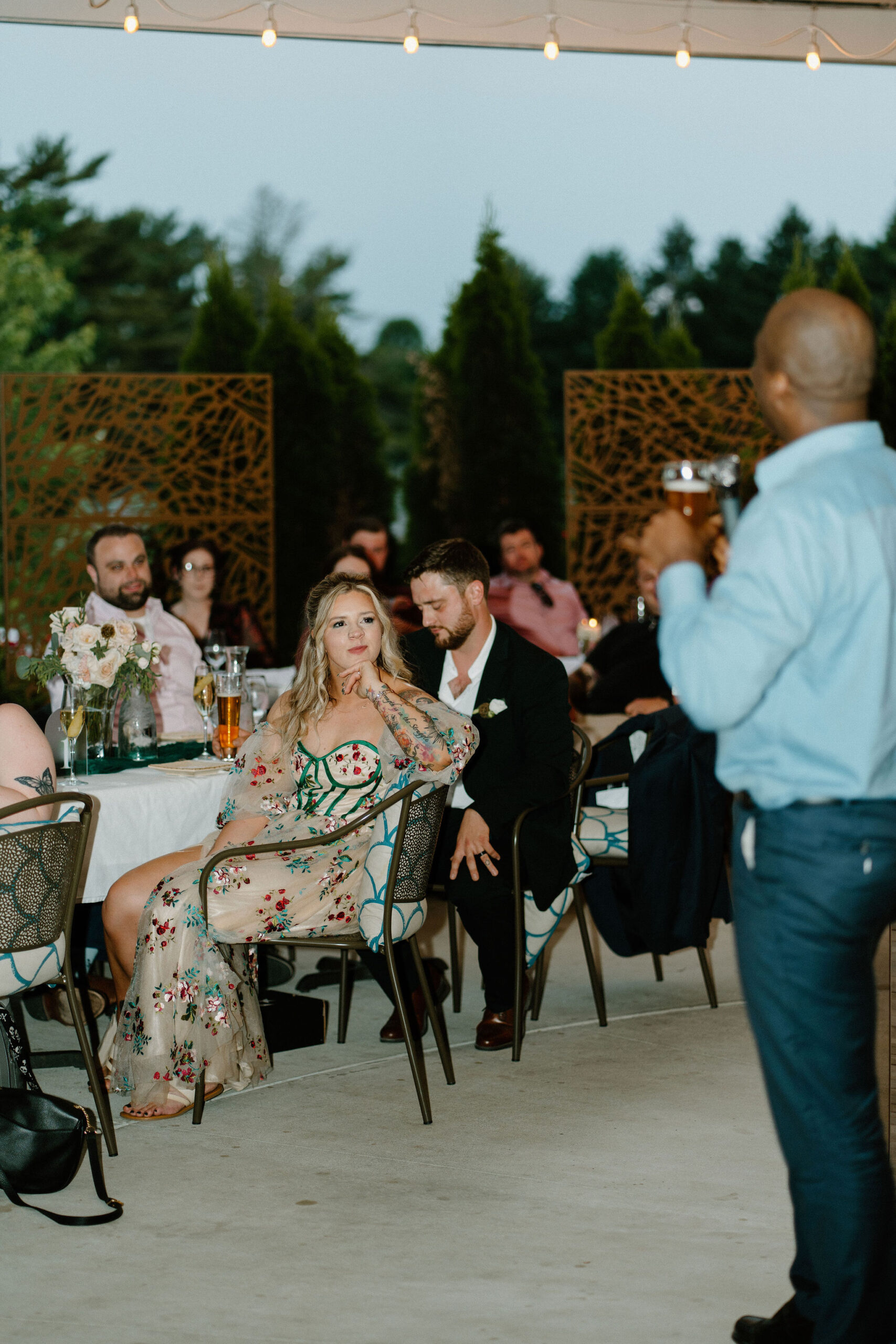 bride smiling at the best man during his speech