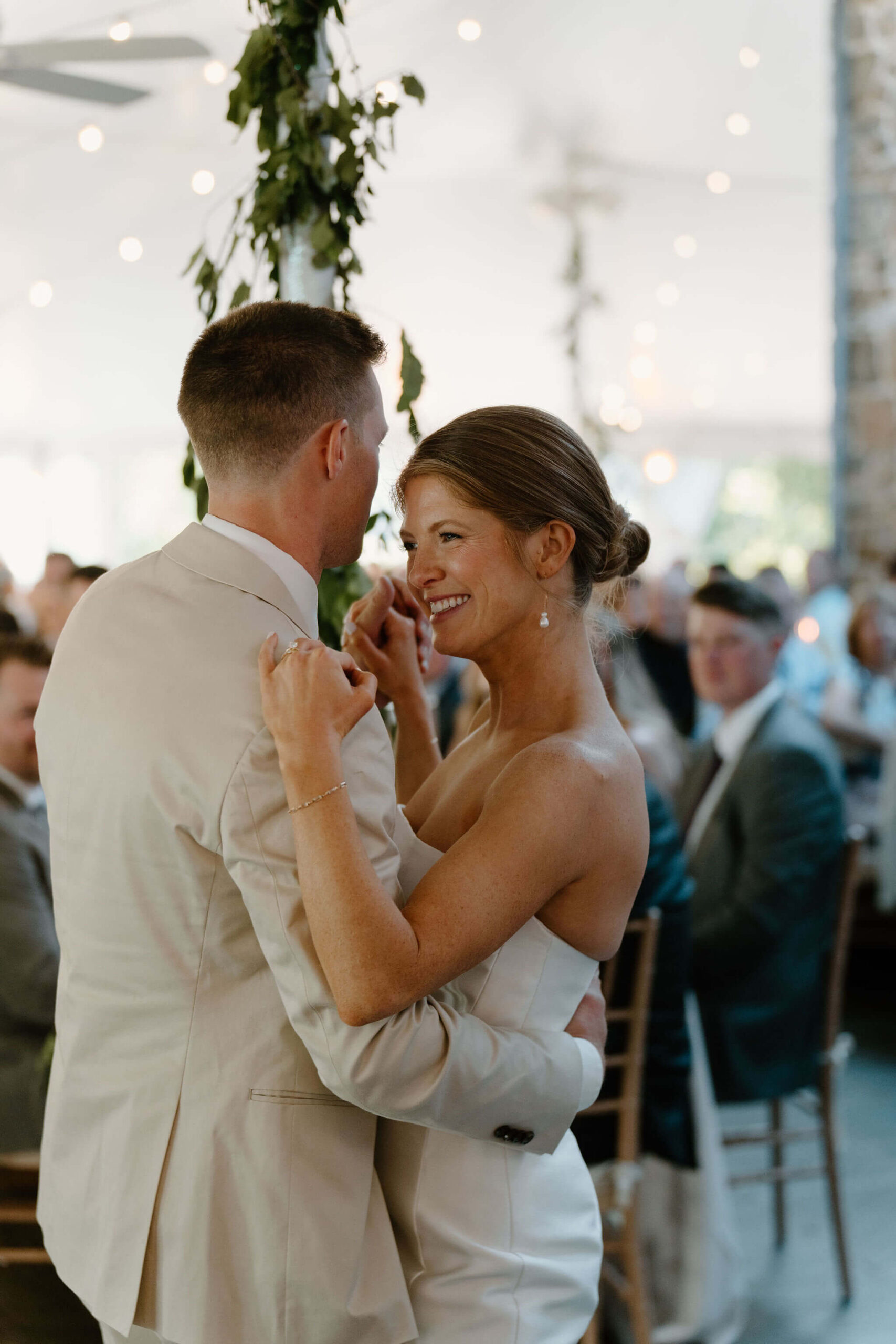 close up of bride and groom during their first dance, bride smiling widely