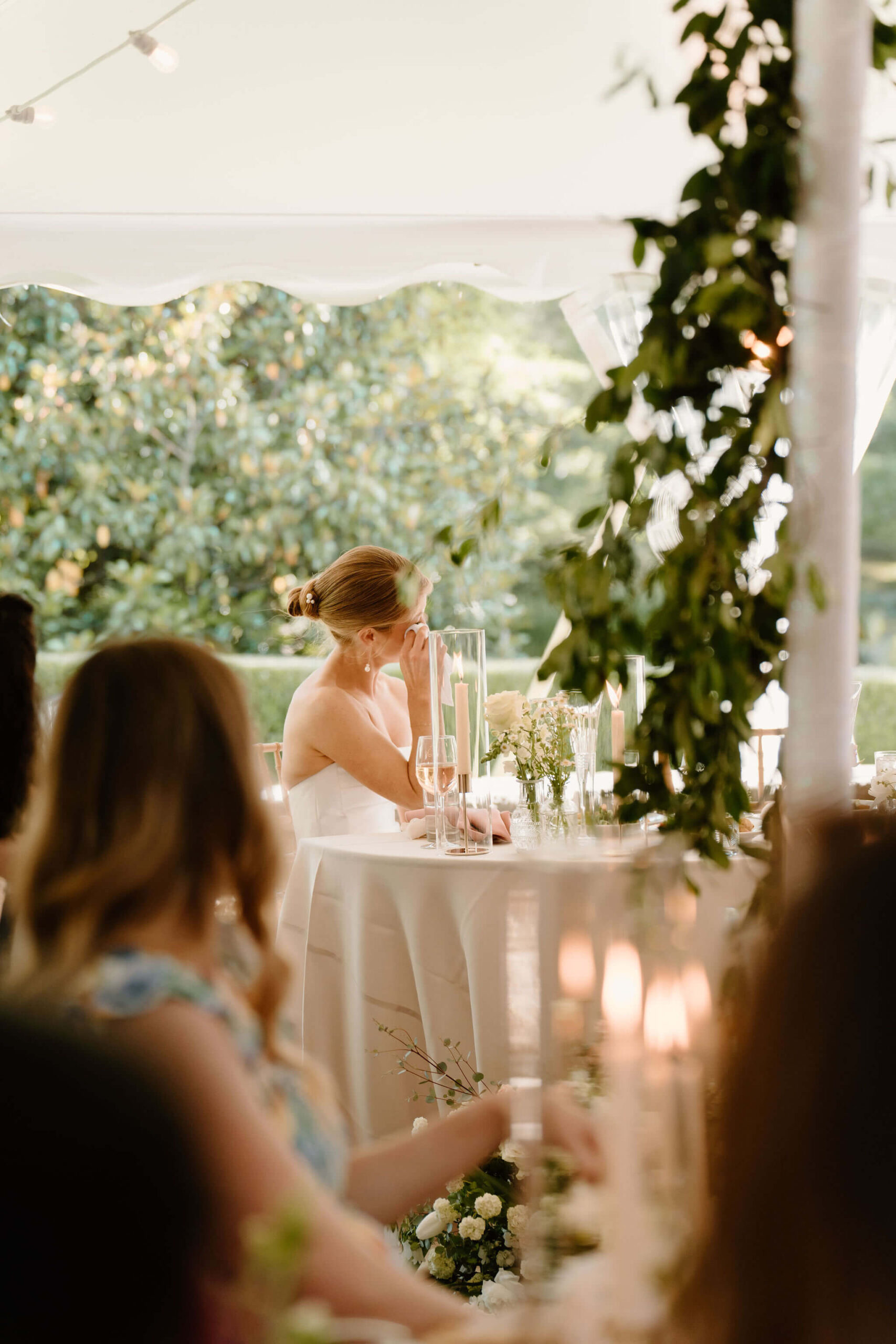 bride crying during speeches, sitting at a sweetheart table