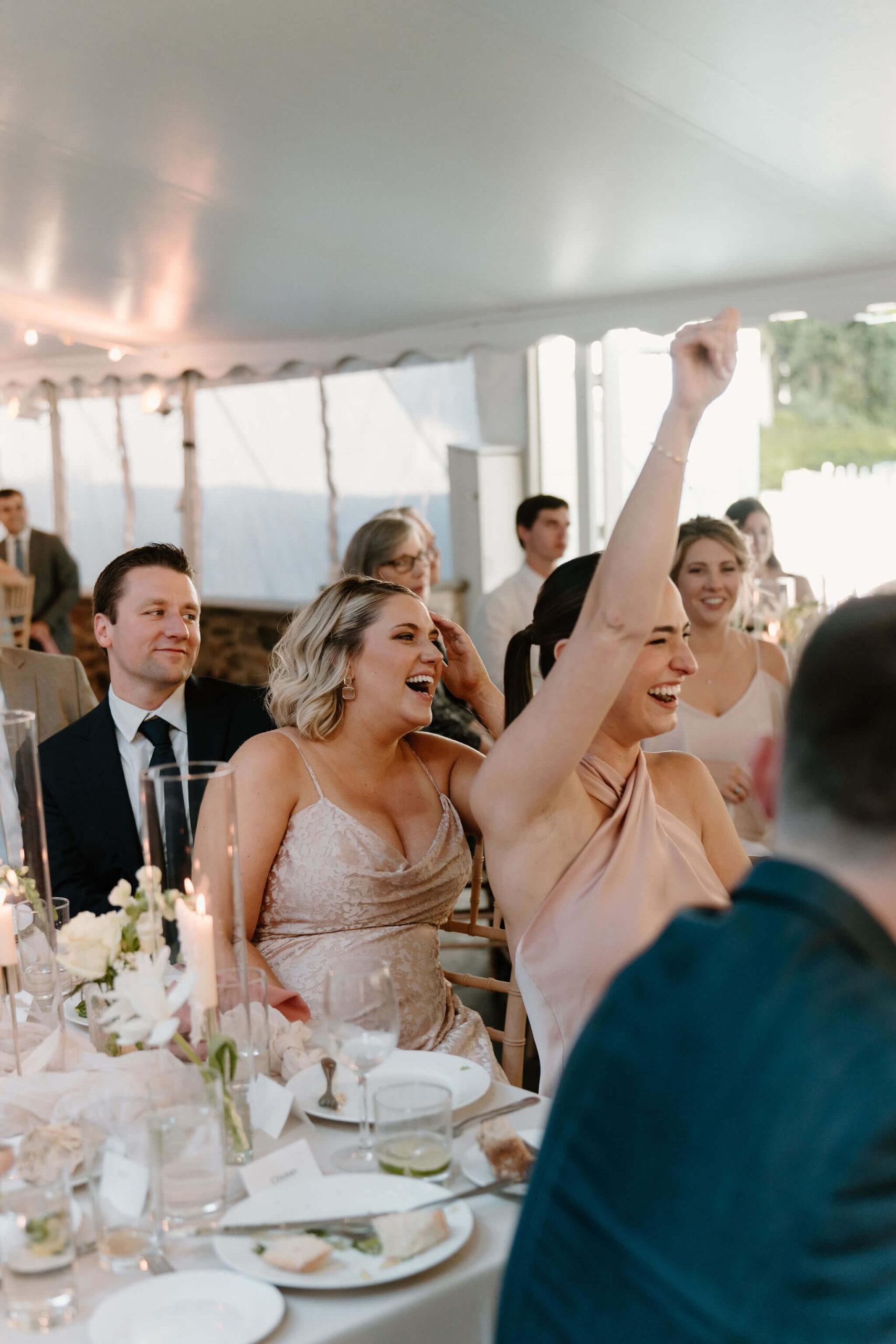 bridesmaids cheering during speeches at wedding reception
