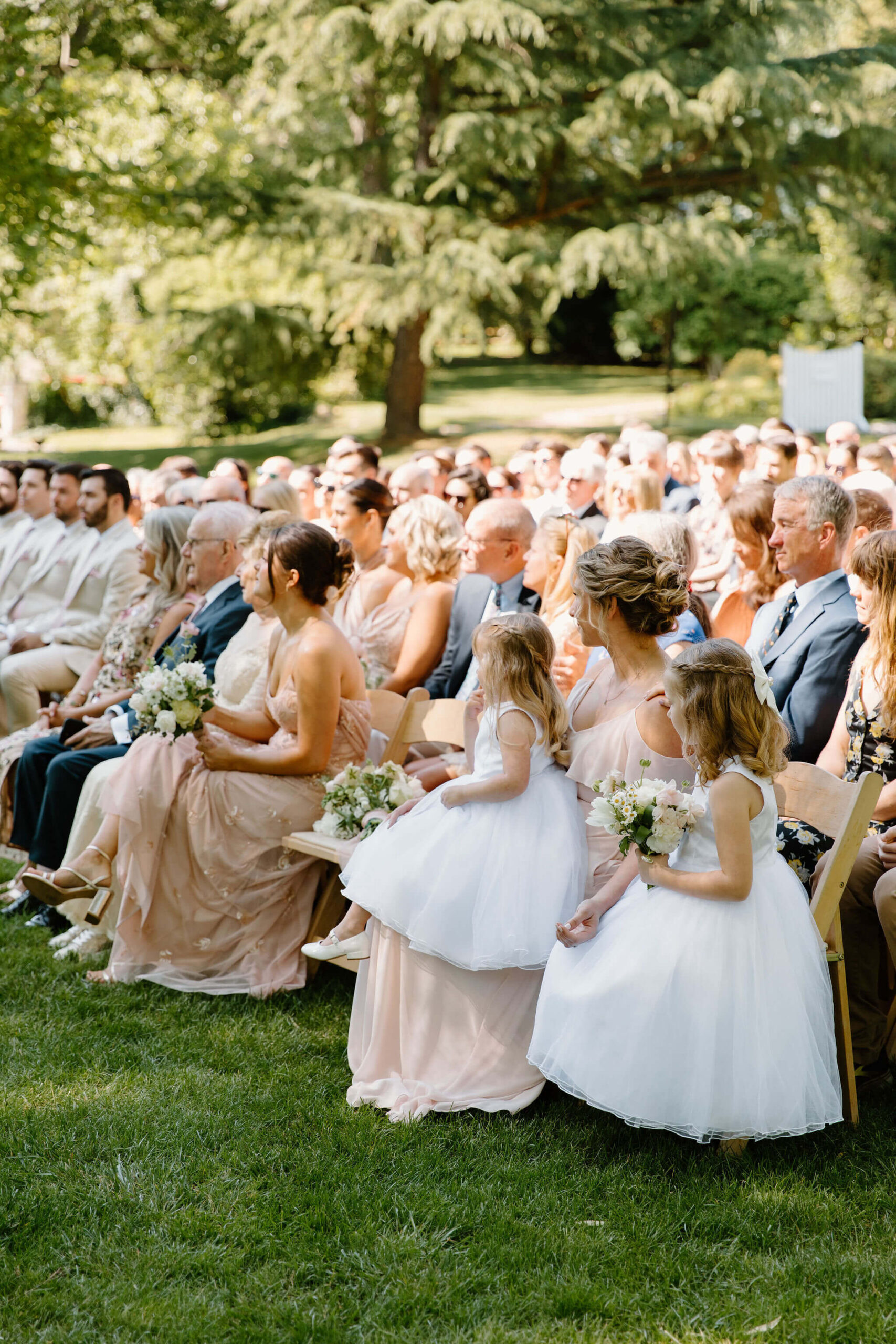 side view of guests watching a wedding ceremony
