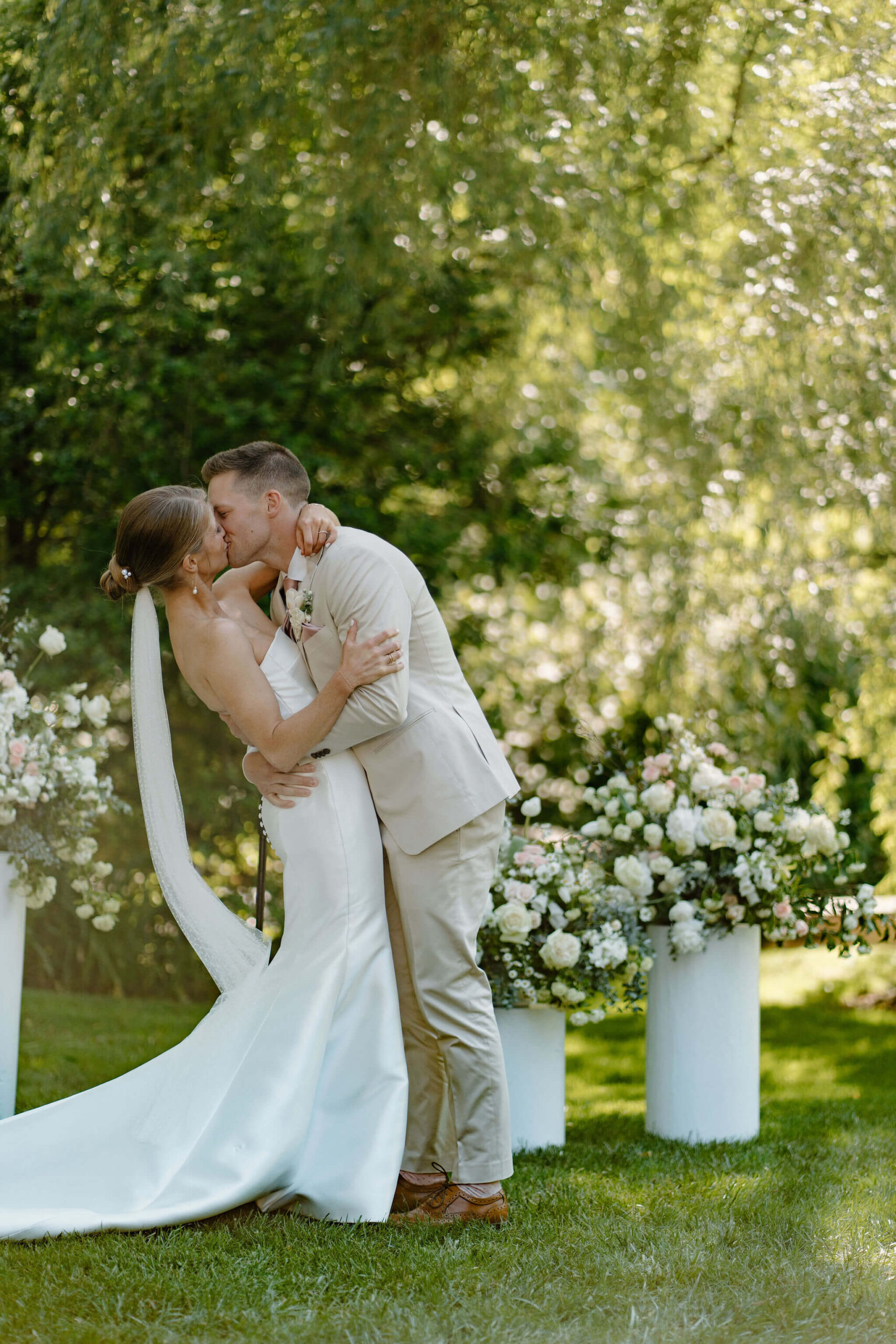 bride and groom kissing at the end of their wedding ceremony