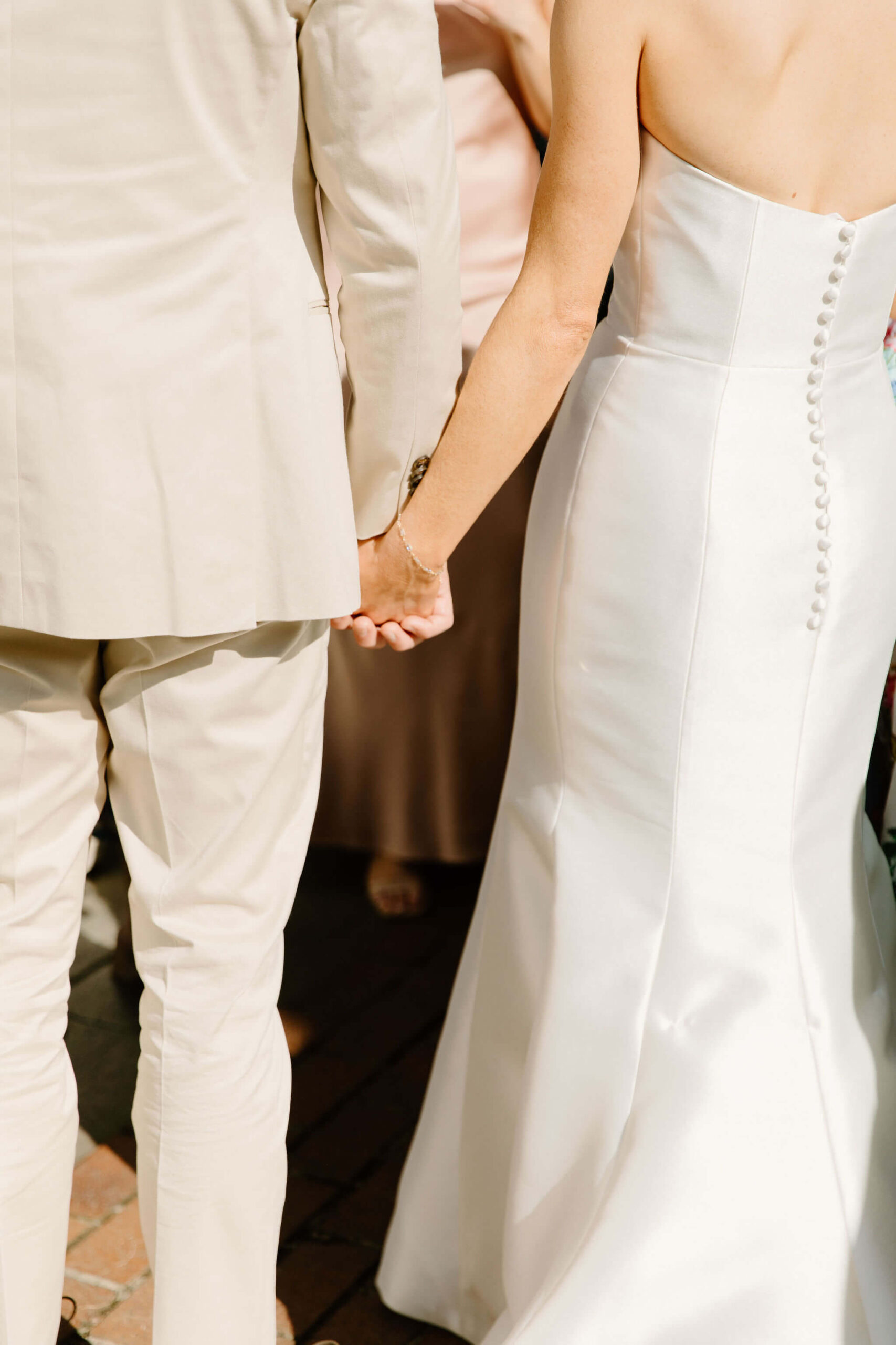 bride and groom holding hands as they greet their guests at cocktail hour