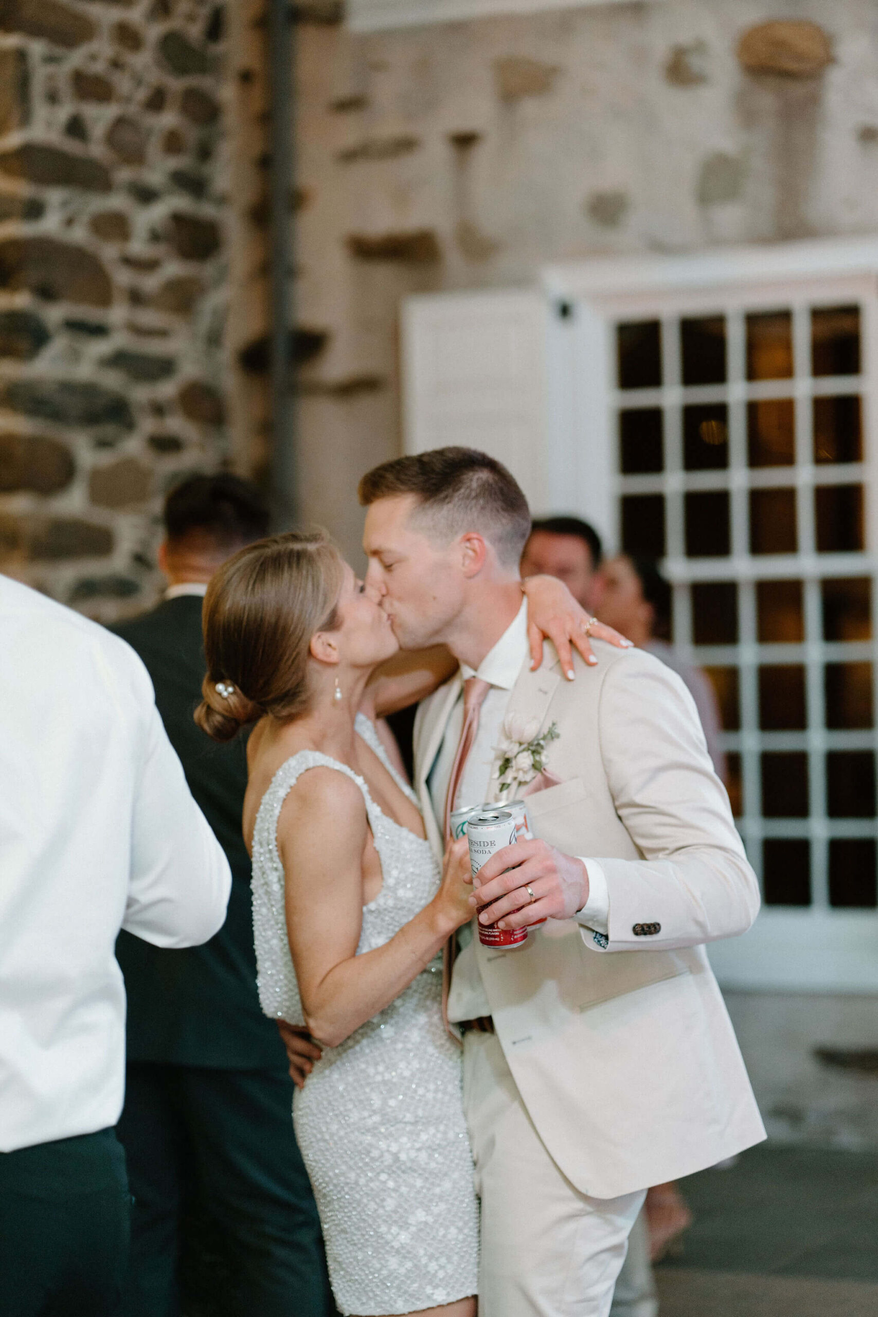 bride and groom embracing and kissing during their wedding reception