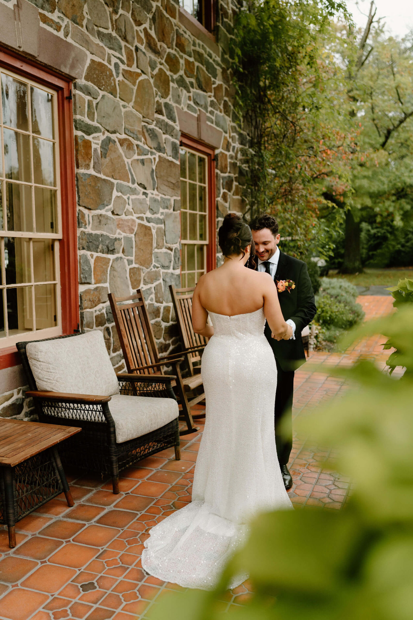 groom admiring his bride's wedding dress