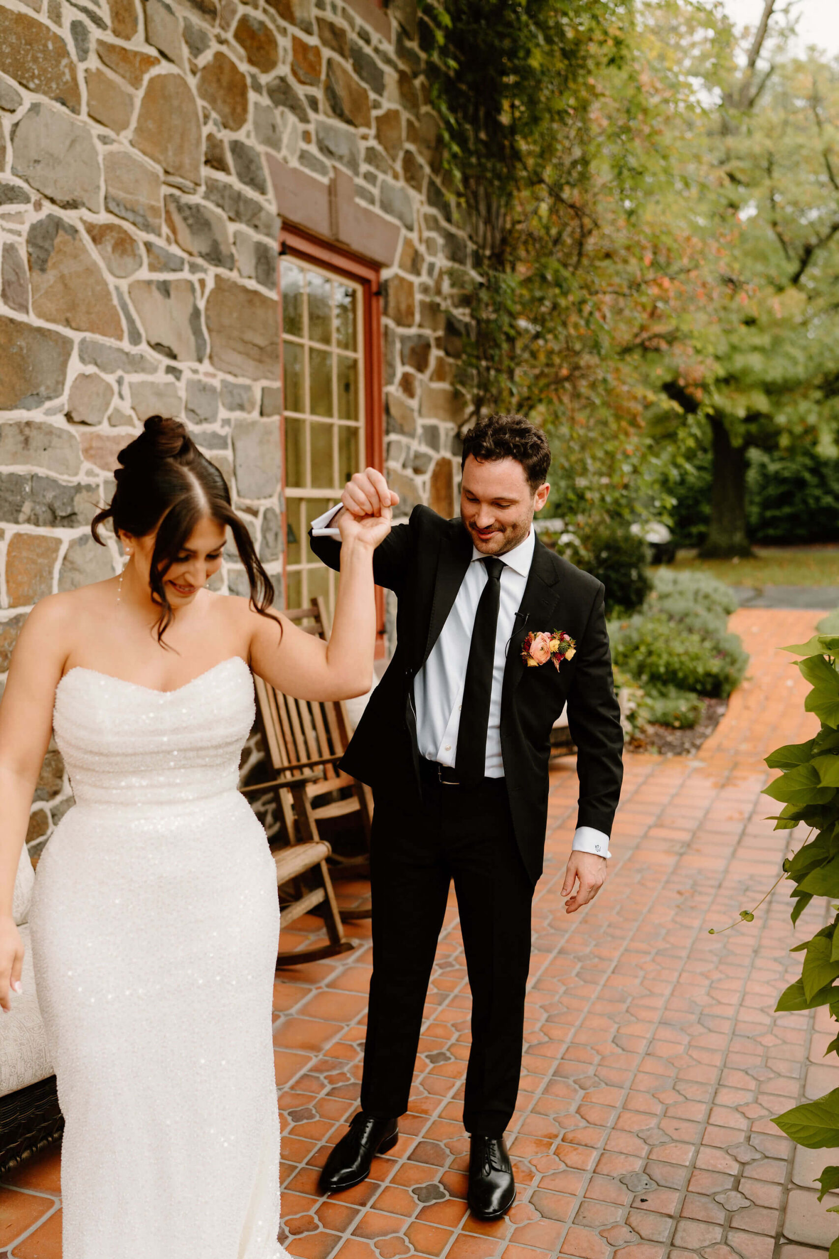 groom twirling bride to see her wedding dress