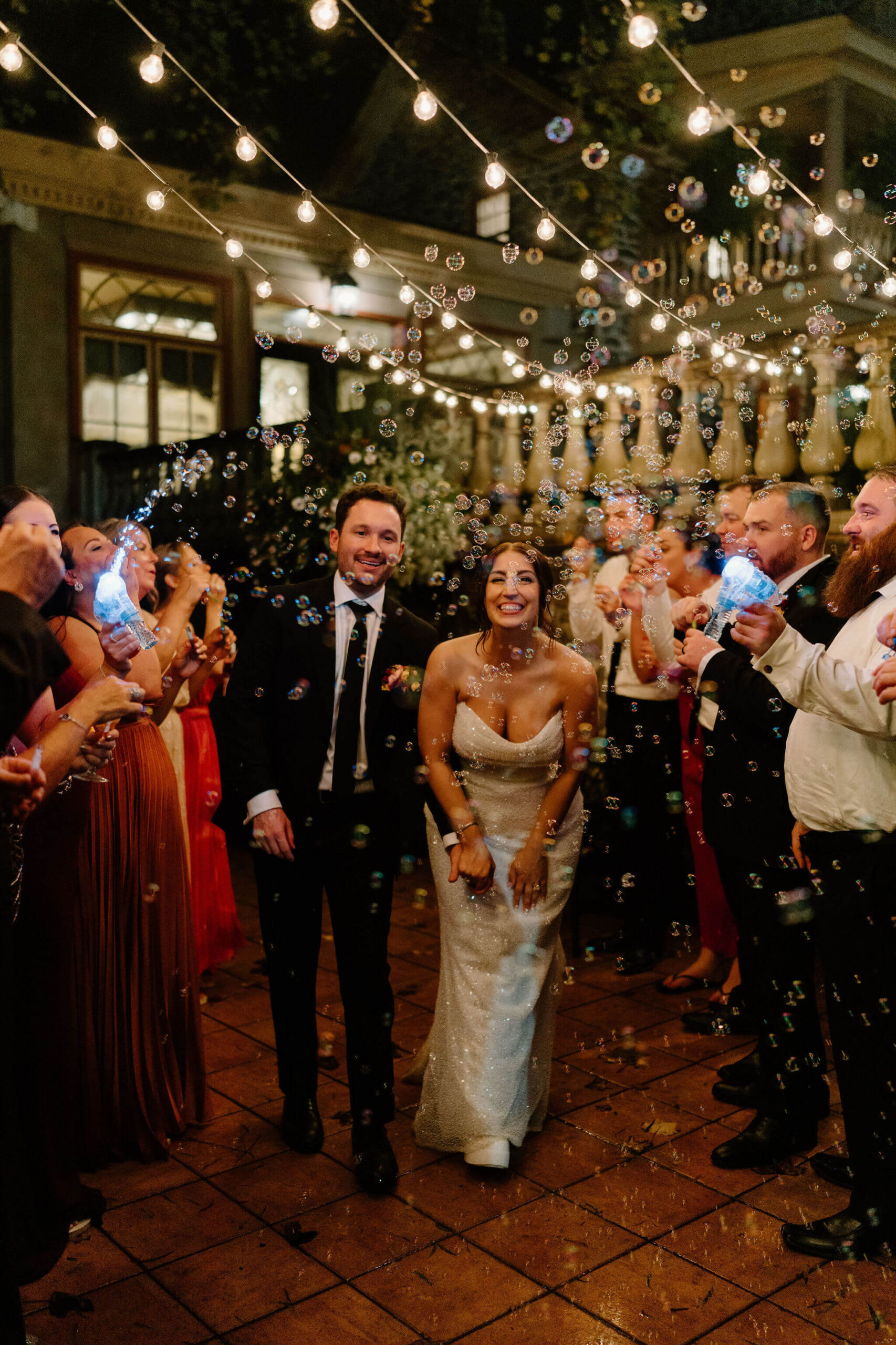 bride and groom having a bubble send off at the end of their fall wedding reception 