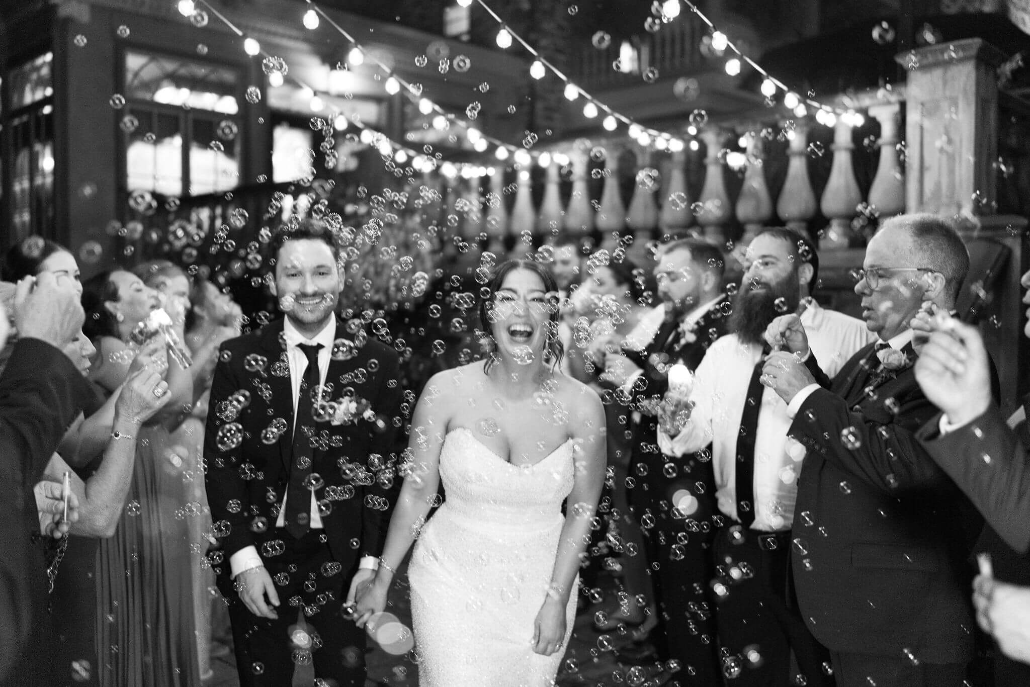 bride and groom having a bubble send off at the end of their fall wedding reception 