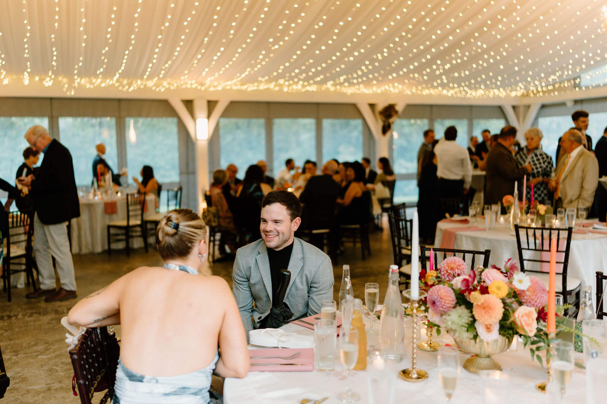 guests seated at tables during cocktail hour and talking