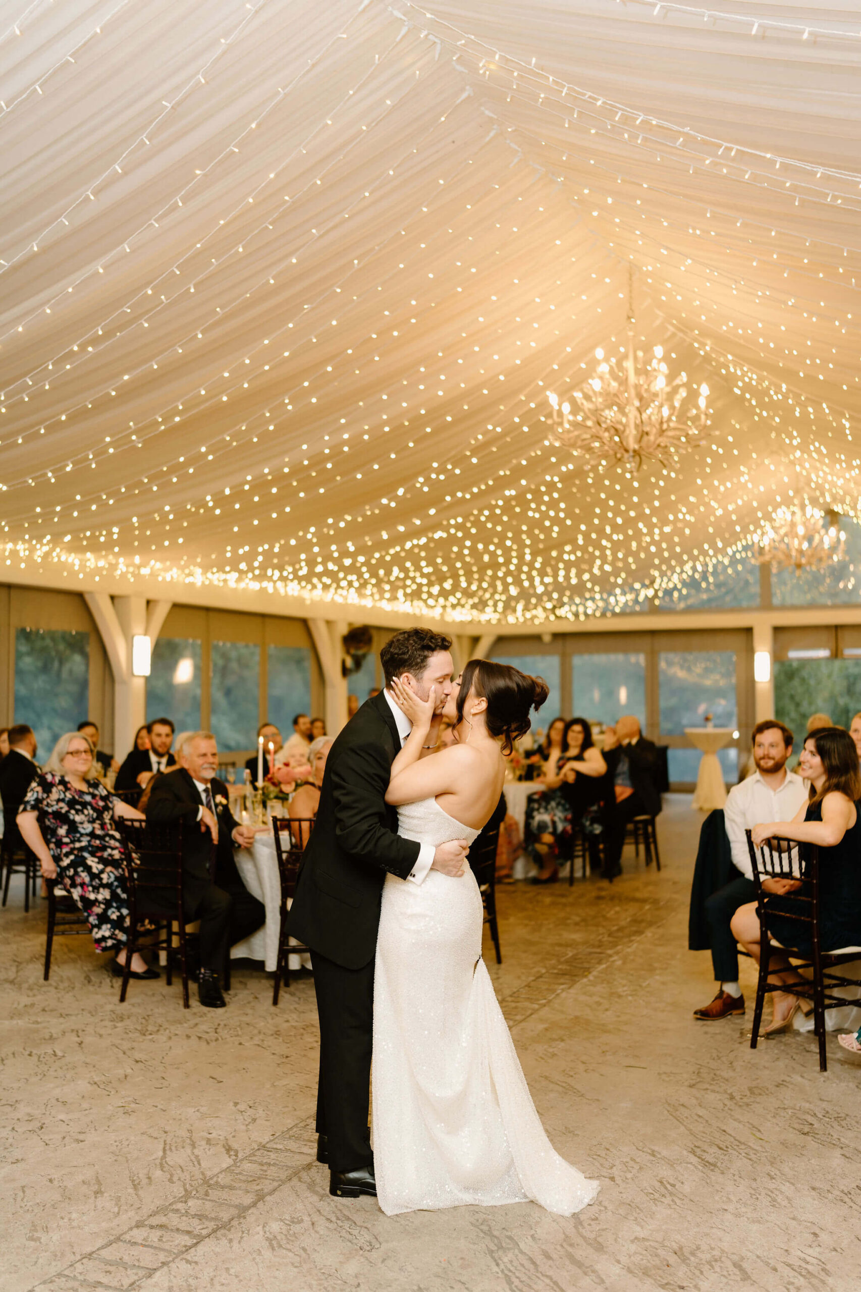 bride and groom sharing a kiss at the end of their first dance during their wedding reception