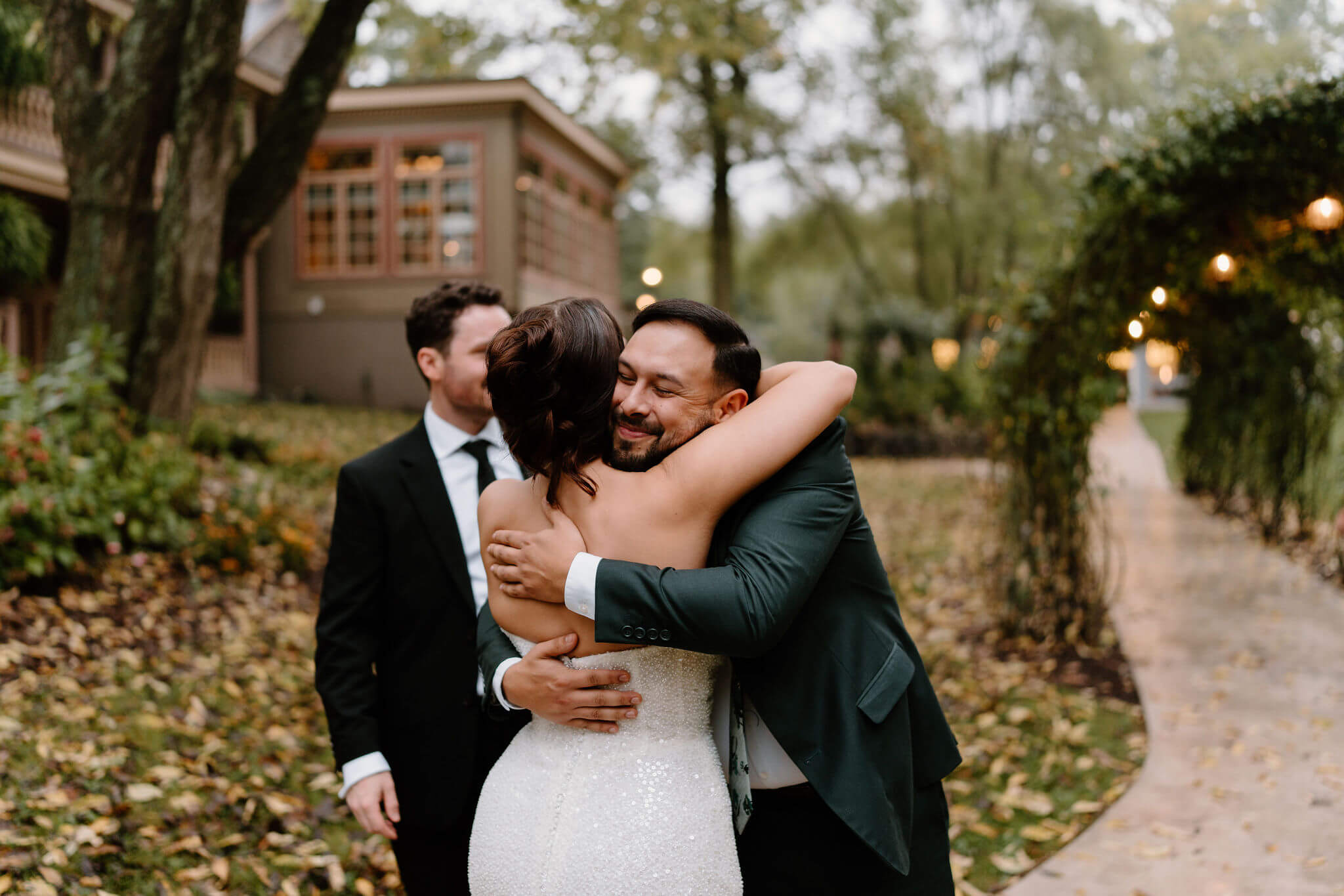 guest hugging bride on their wedding day