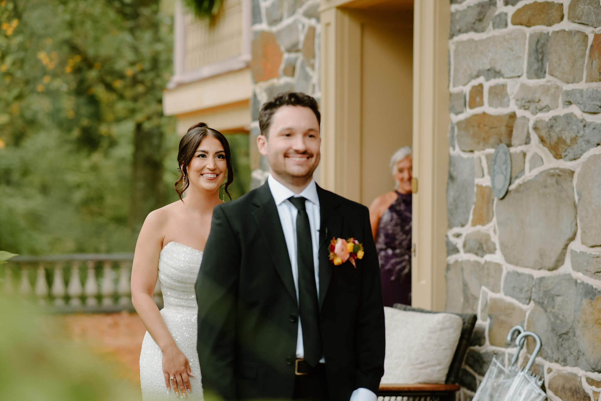 bride approaching groom from behind for their first look, both smiling