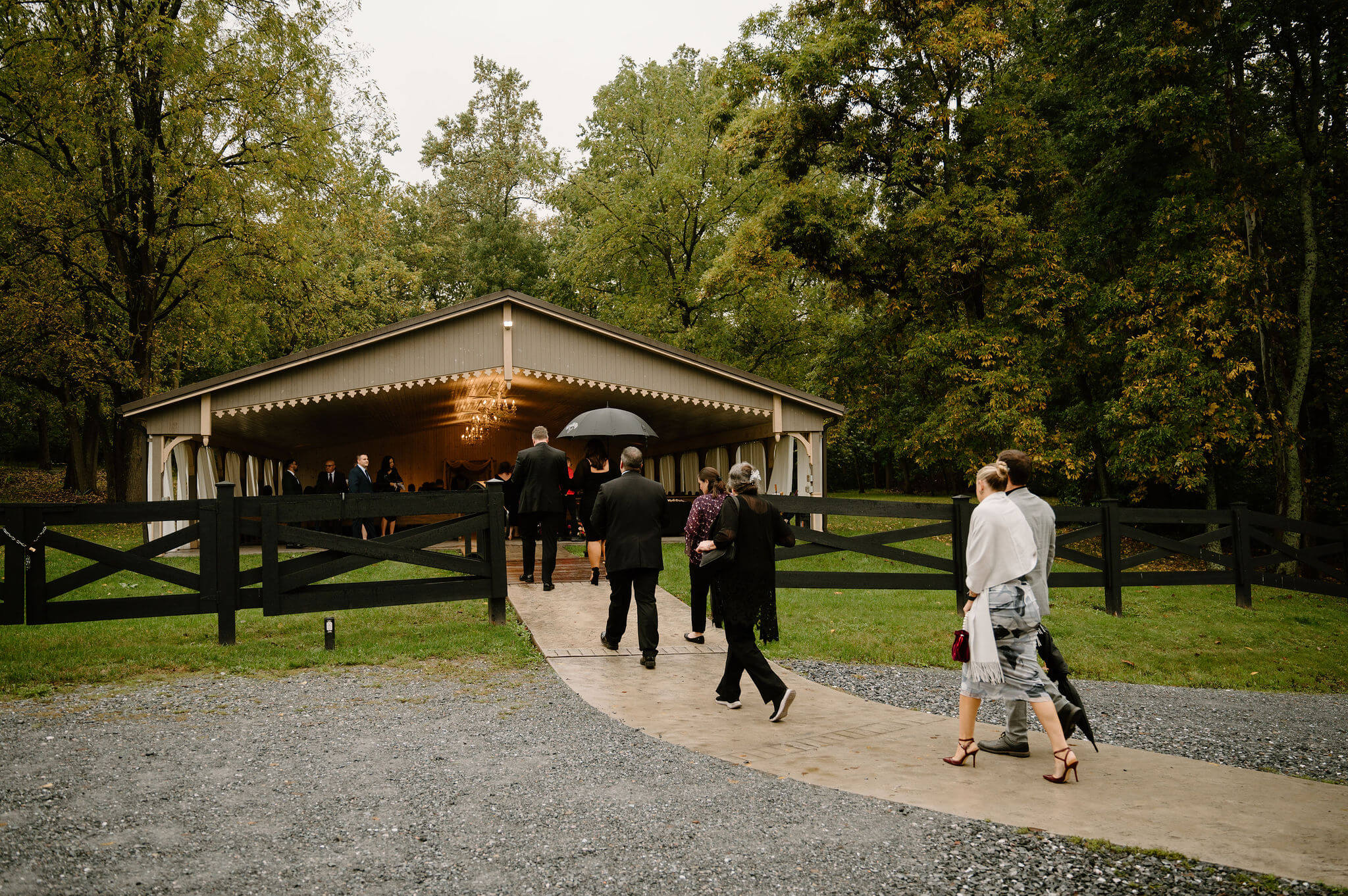 guests arriving to ceremony structure, a covered pavilion tucked in the woods