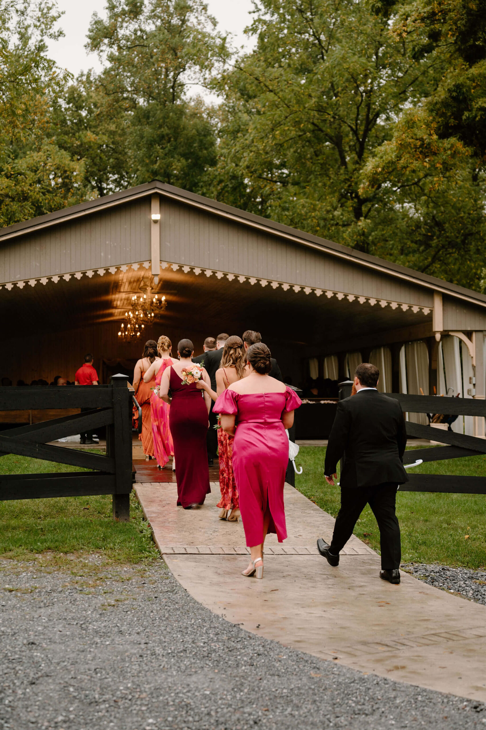 bridesmaids and groomsmen walking up the path to the wedding ceremony