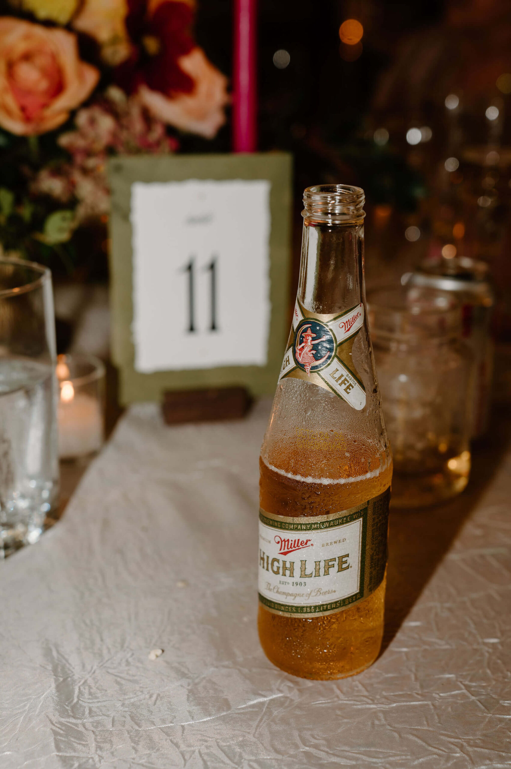 close up image of a Miller High Life (the champagne of beers) on a wedidng reception table