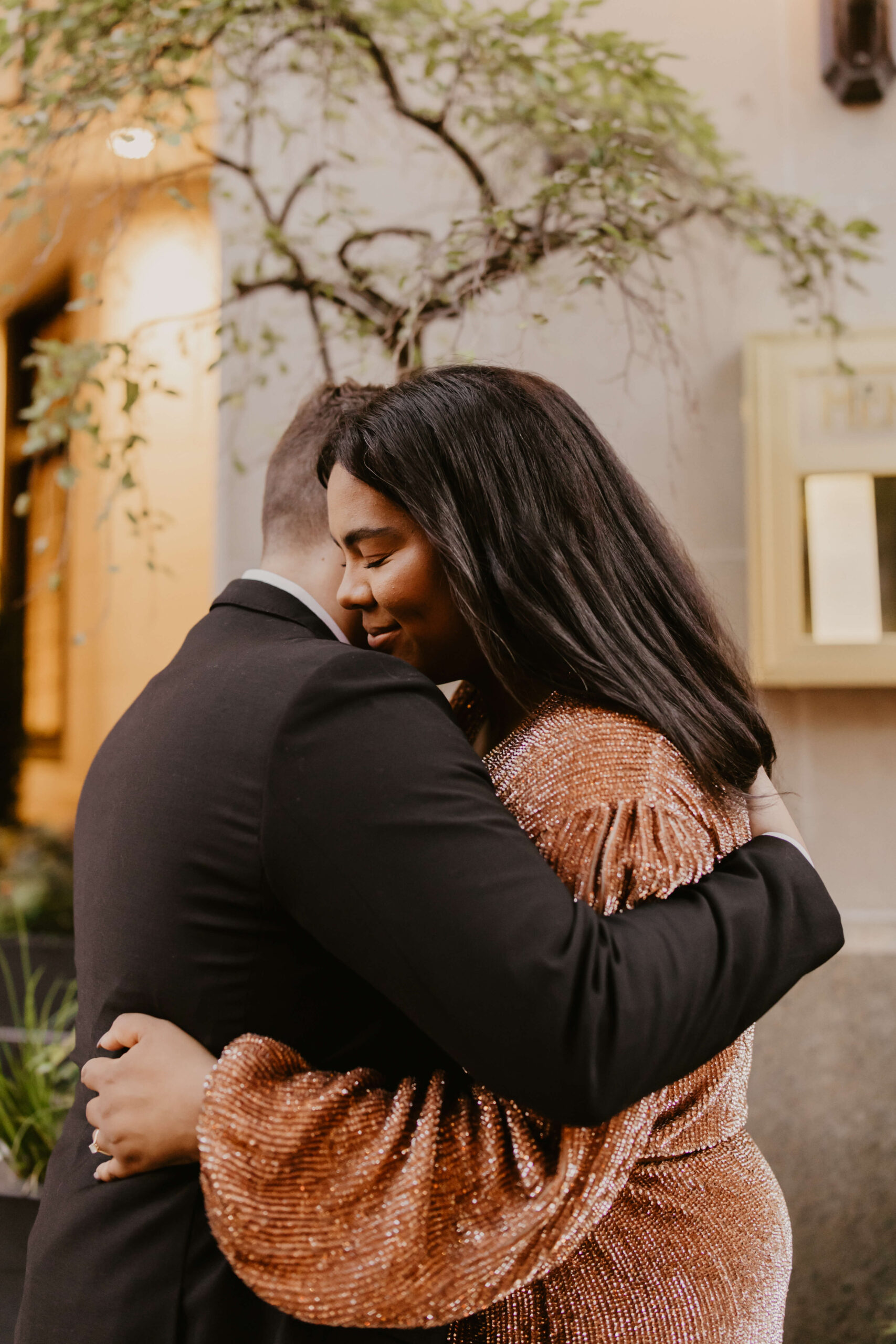 engaged couple embracing on the streets of Philadelphia