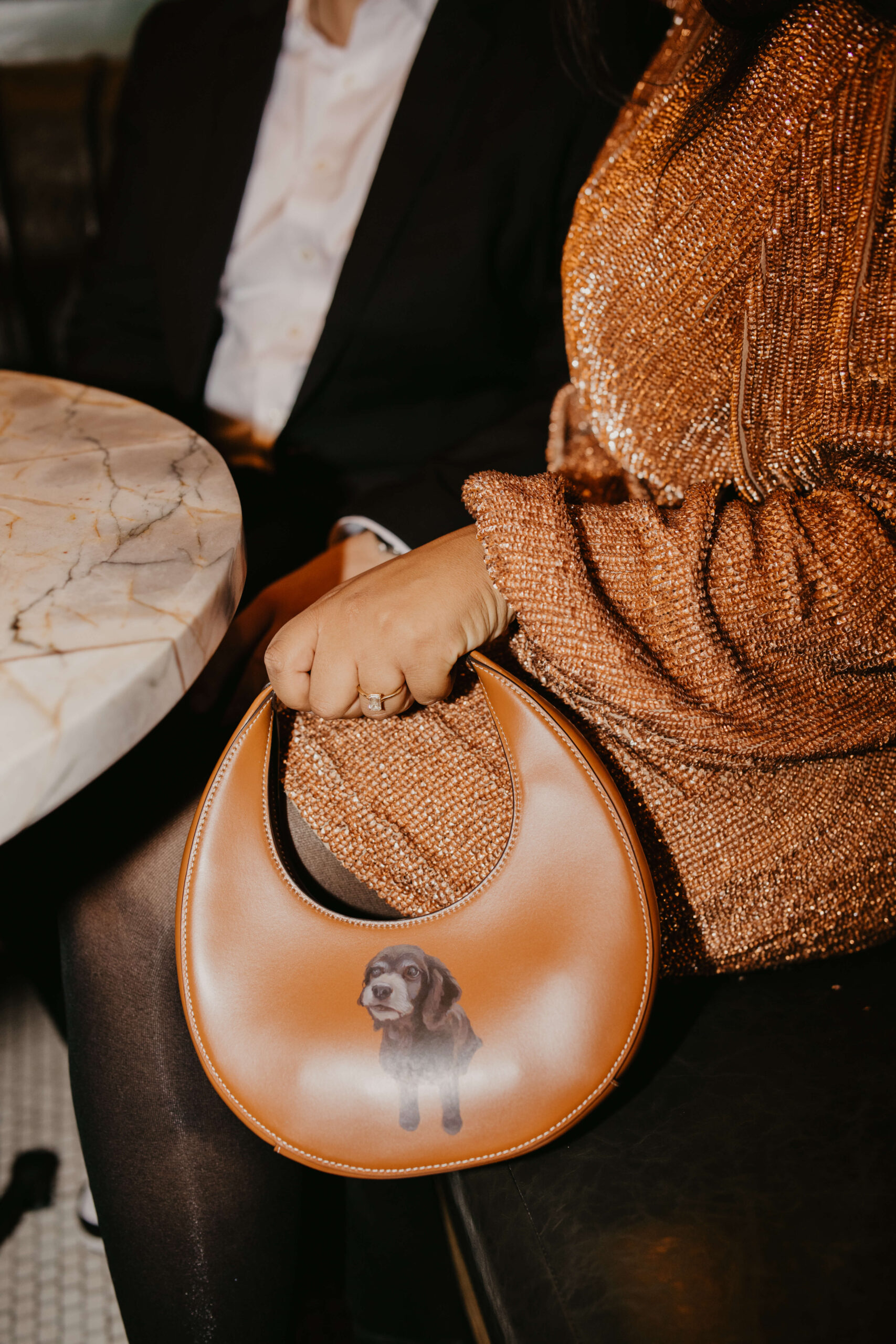 close up of bride holding custom brown leather purse with an image of their dog screen printed on it