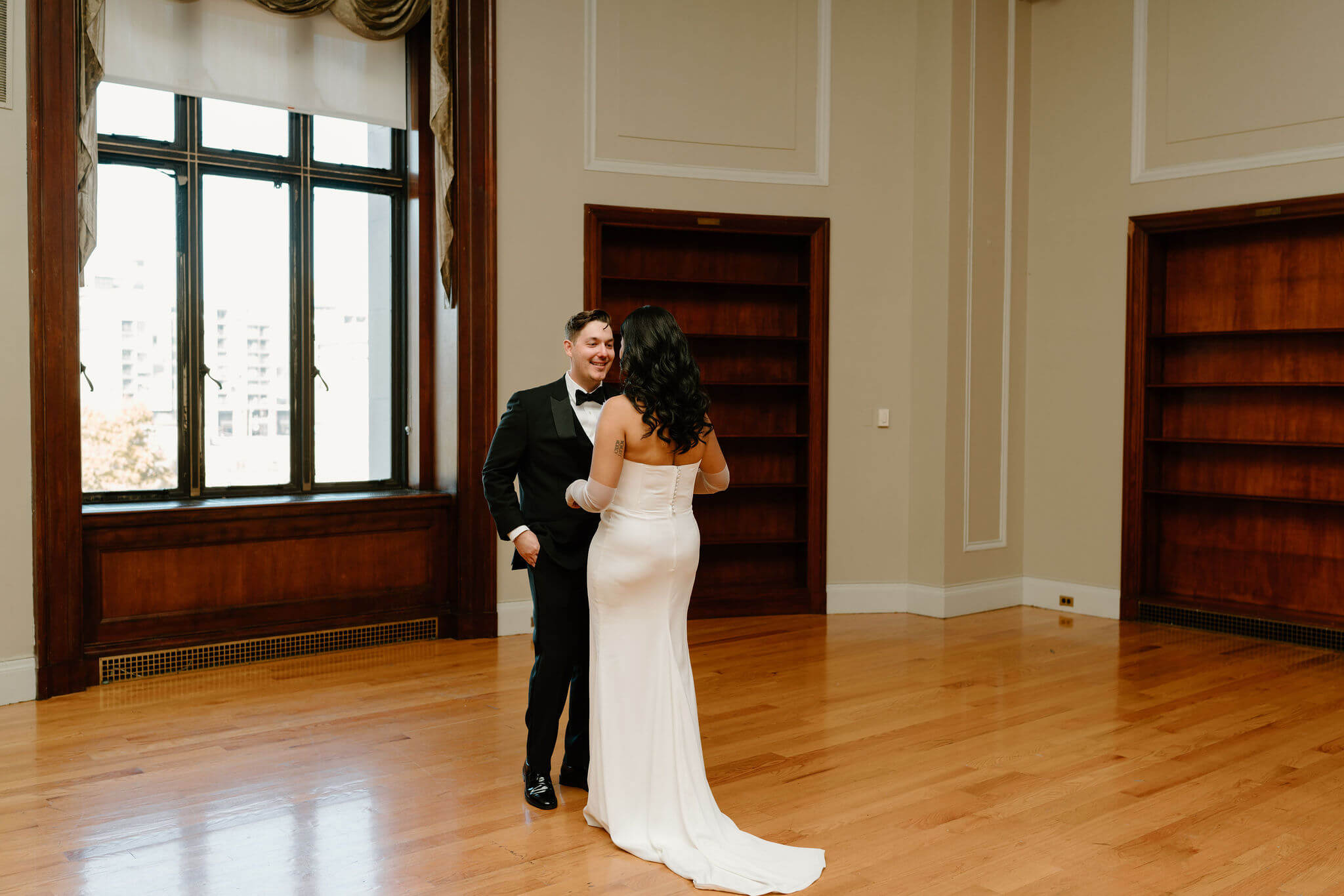 groom smiling widely as he turns to see his bride for the first time on their wedding day