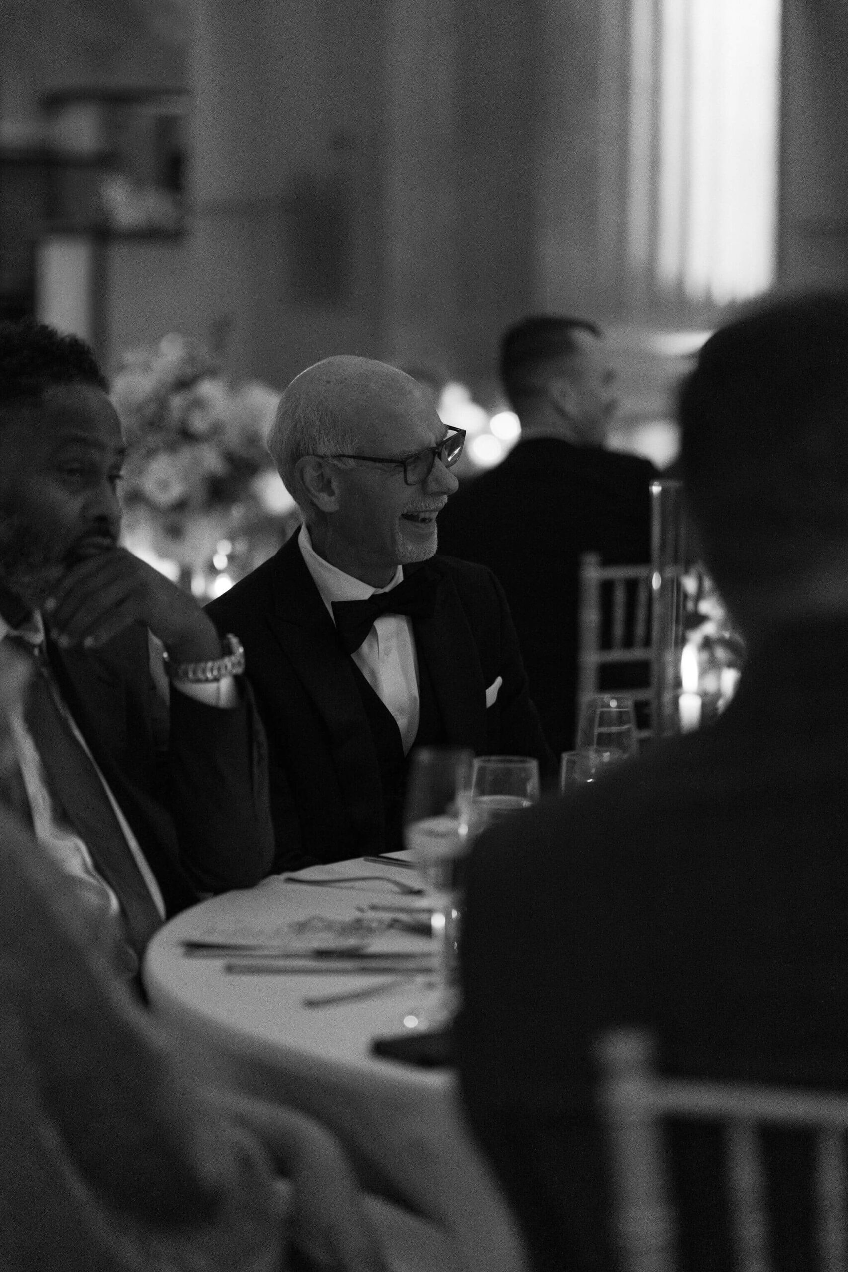 father of the groom smiling widely during formalities of a wedding reception