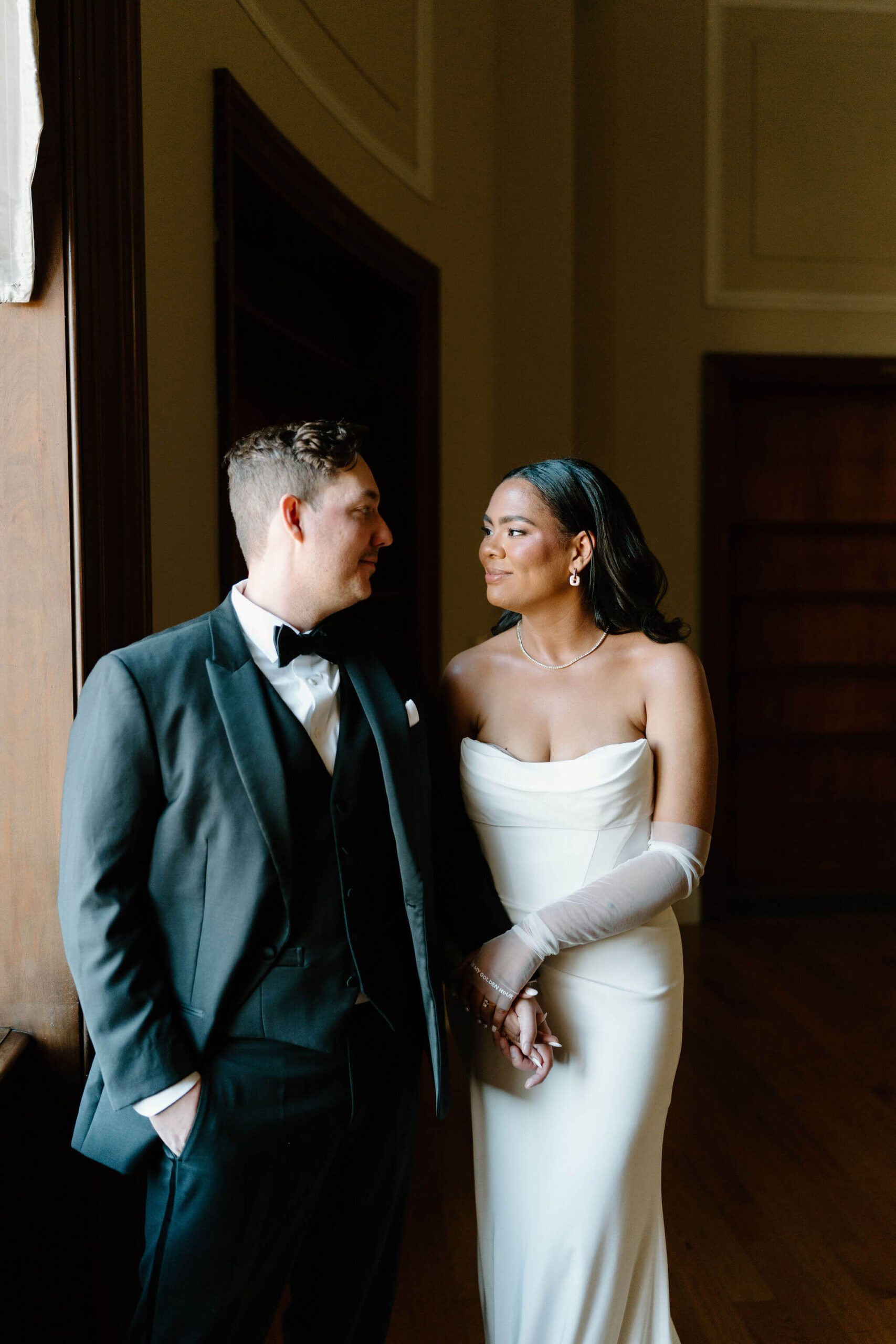 bride and groom looking at each other and smiling on their wedding day
