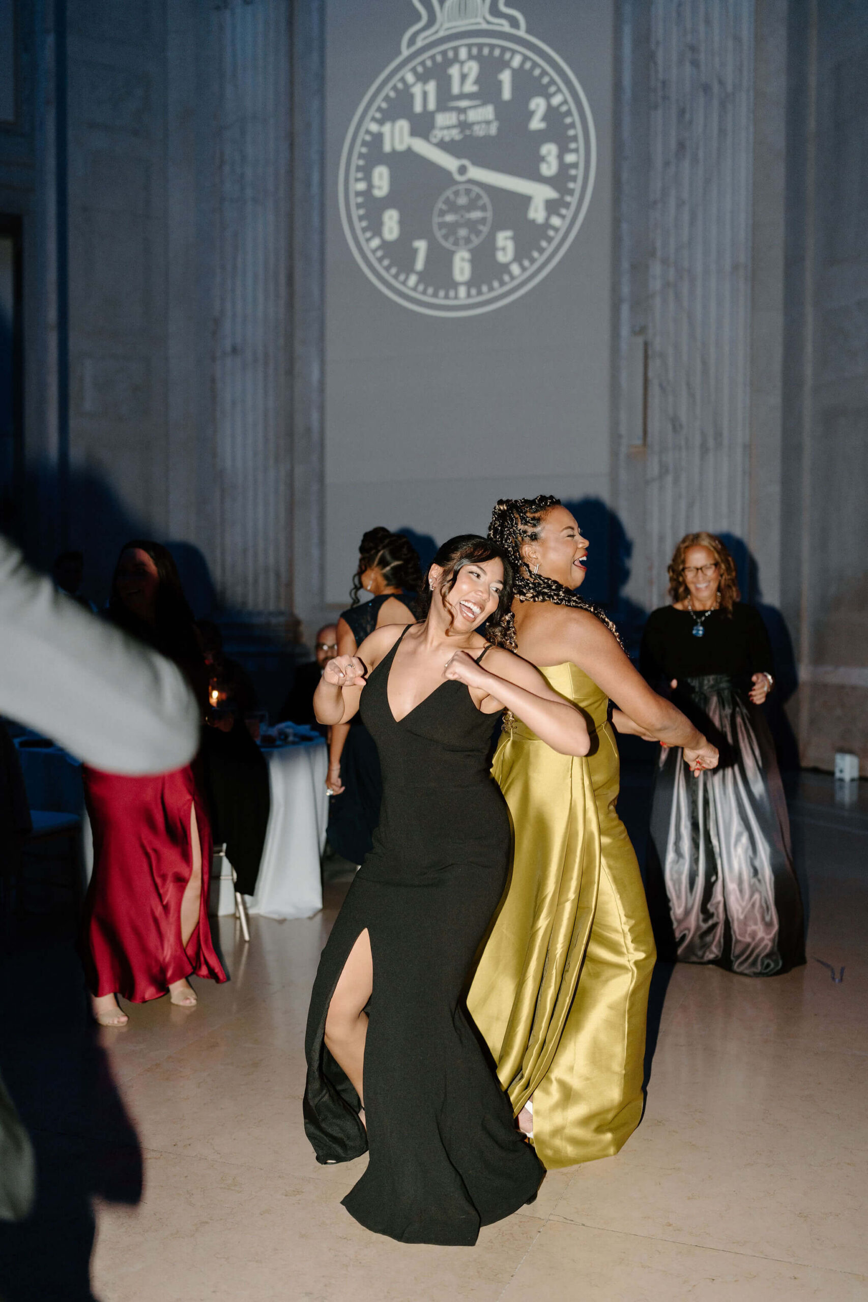 two guests dancing and smiling at a wedding reception