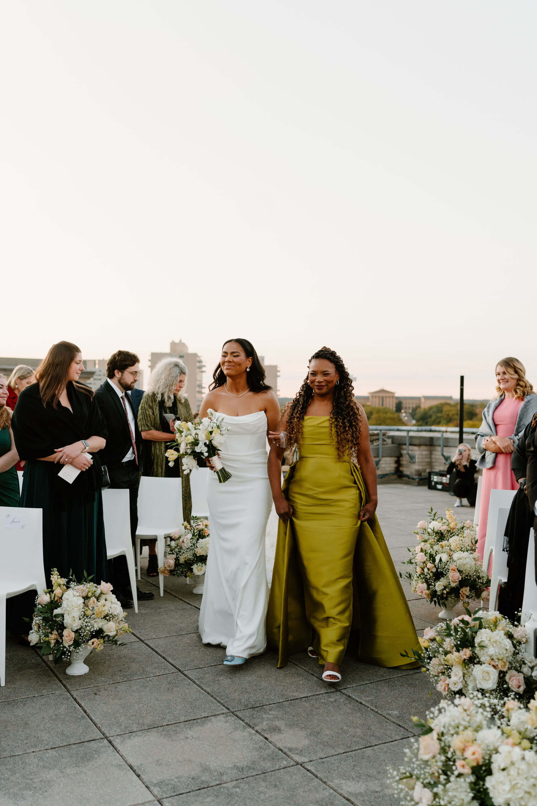 bride and her mother walking down the aisle for her wedding ceremony