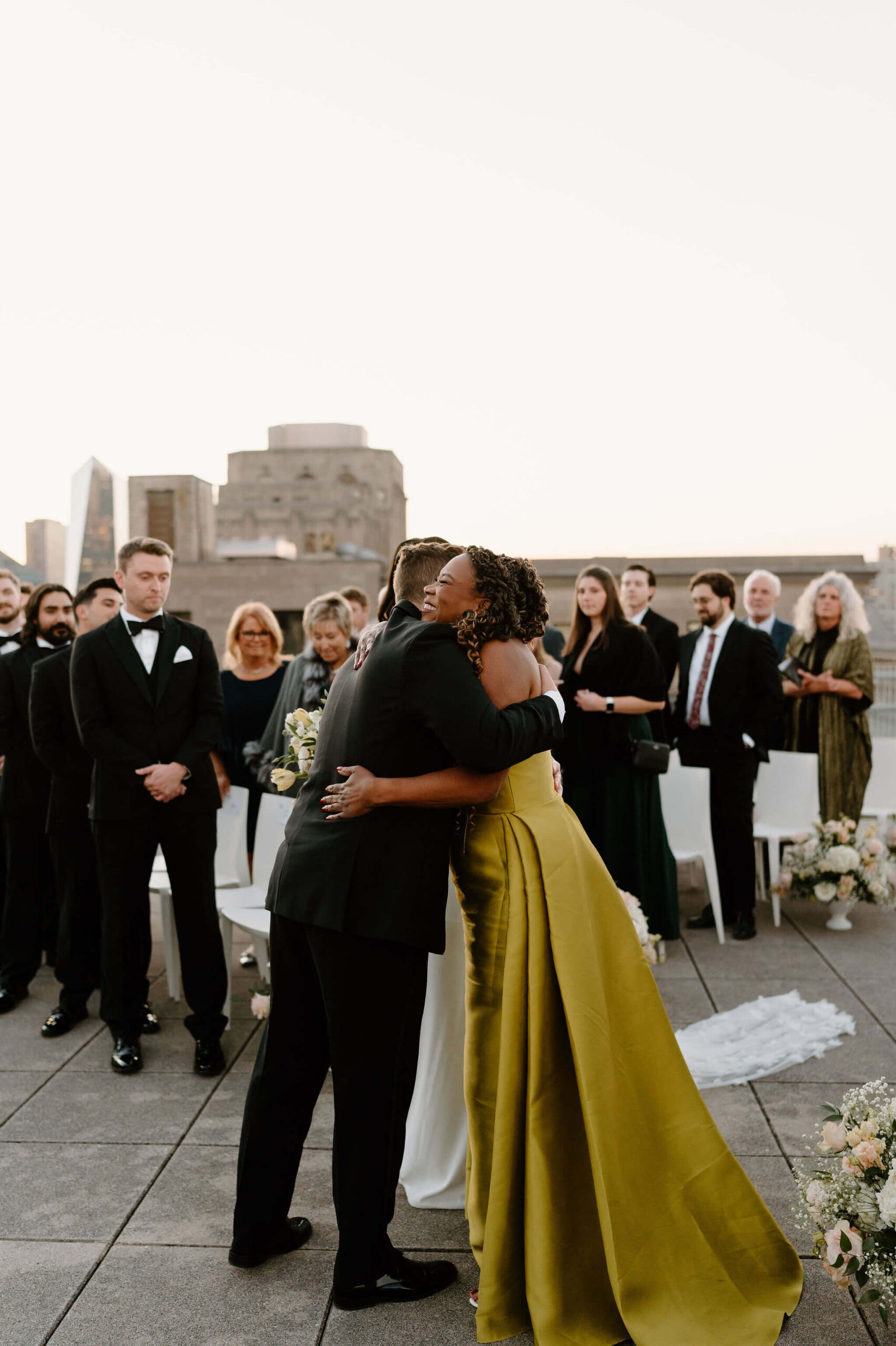 groom hugging the mother of the bride at the end of the aisle during wedding ceremony