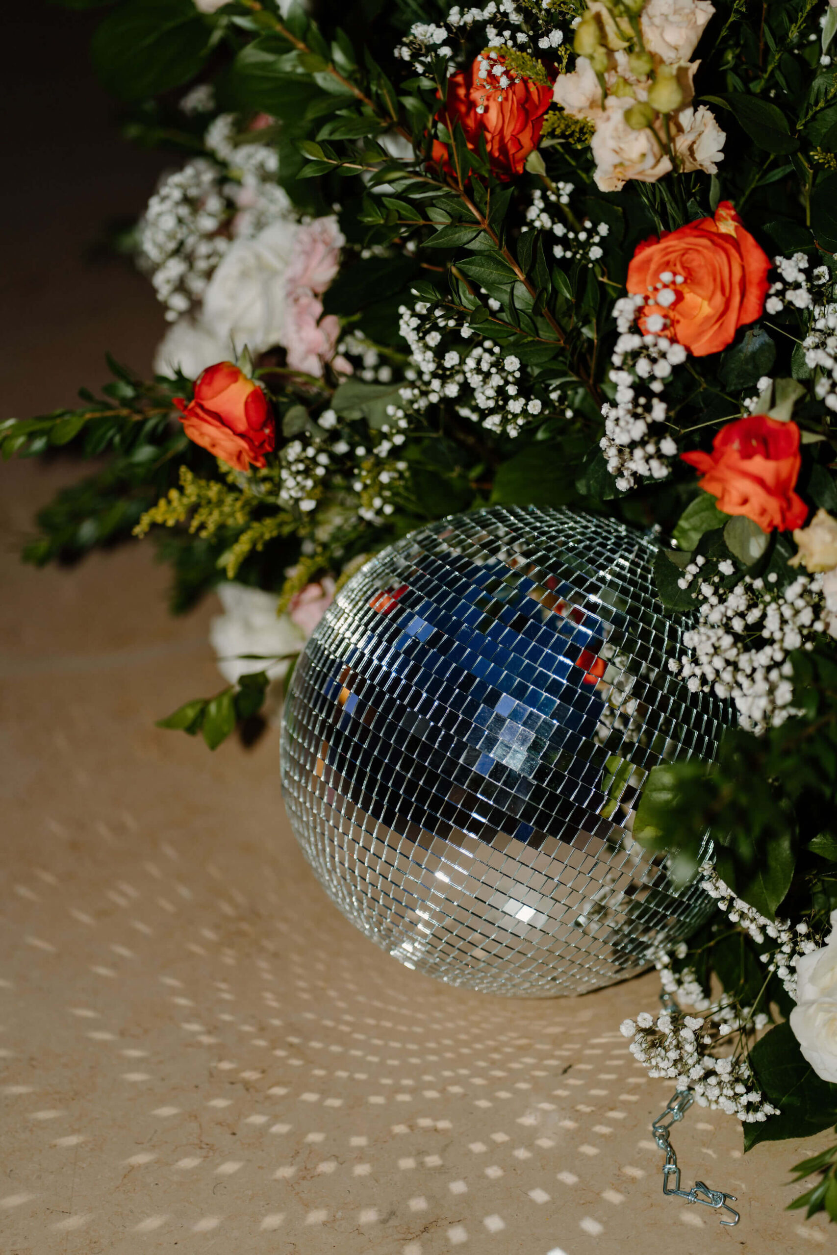 close up of a disco ball surrounded by a large floral installation