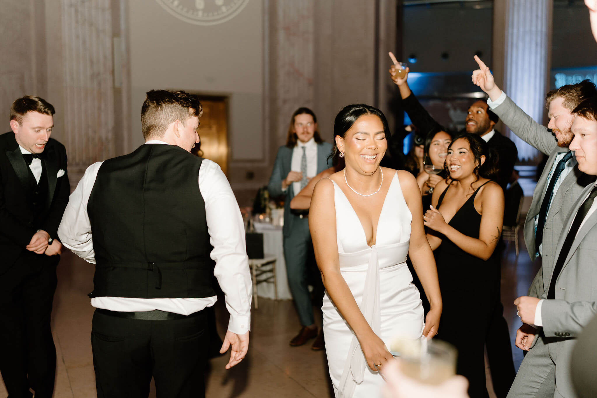 bride smiling and dancing during her wedding reception
