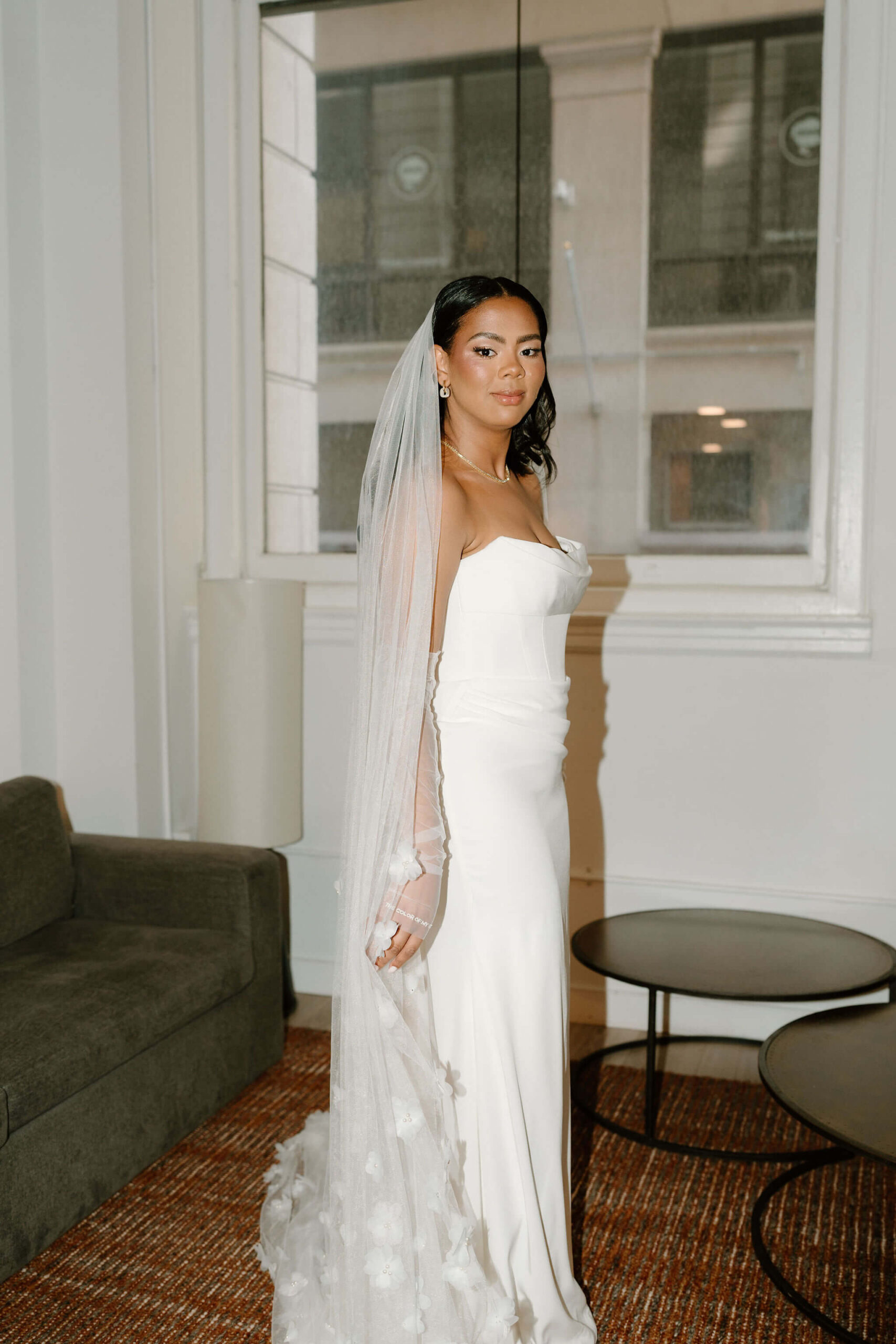 bride in her wedding gown, smiling softly at the camera