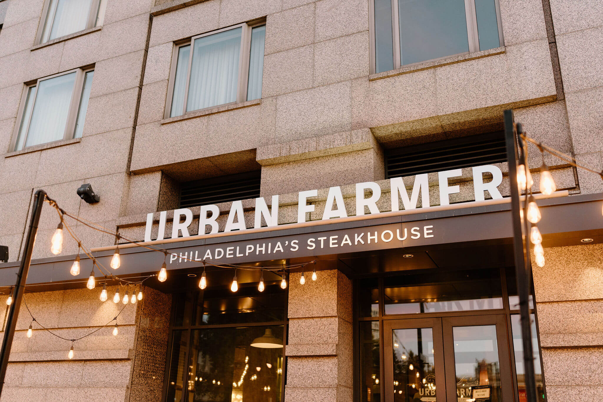 exterior image a restaurant's sign, reading "Urban Farmer: Philadelphia's Steakhouse"