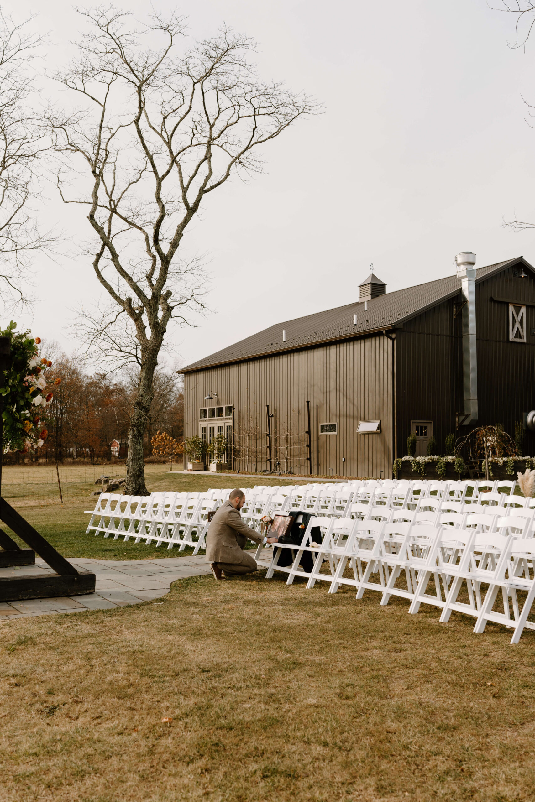 groom placing a memorial of his late parents on their reserved seats prior to his wedding ceremony